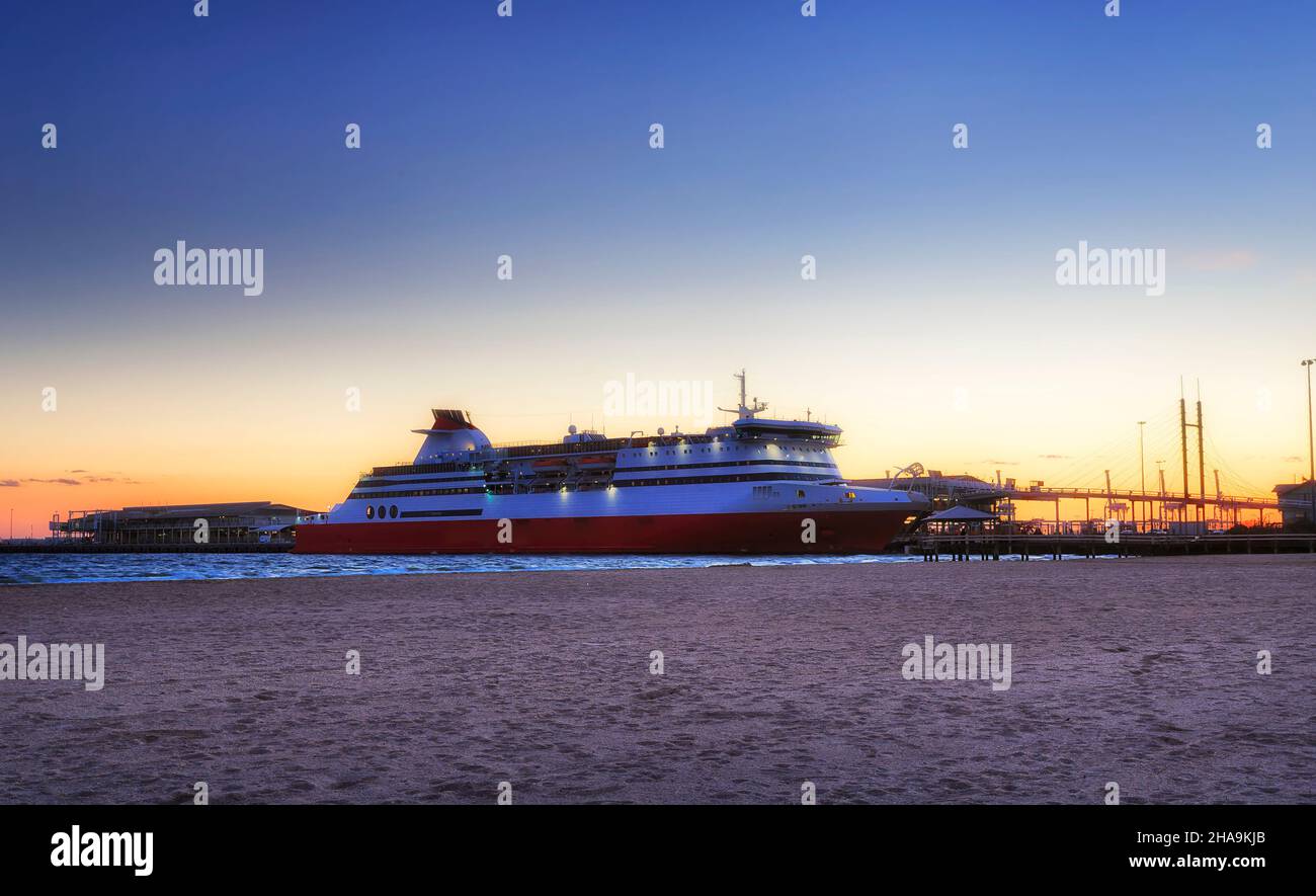 Huge ocean ferry from Melbourne to Devonport in Tasmania arrived to Port Phillip bay at sunset. Stock Photo