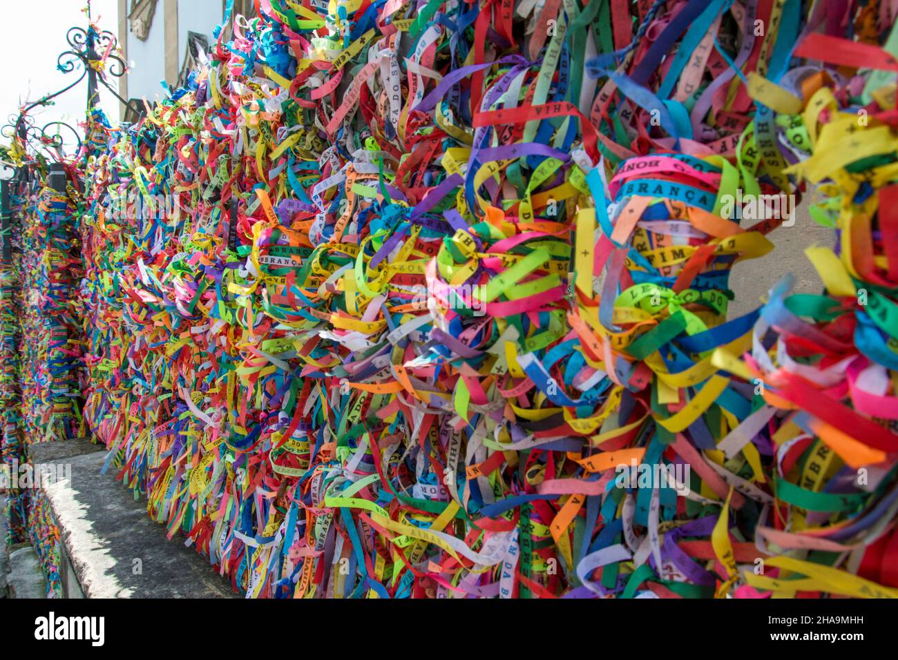 Thousands of colored ribbons tied to a gate. Salvador, Bahia, Brazil. Stock Photo