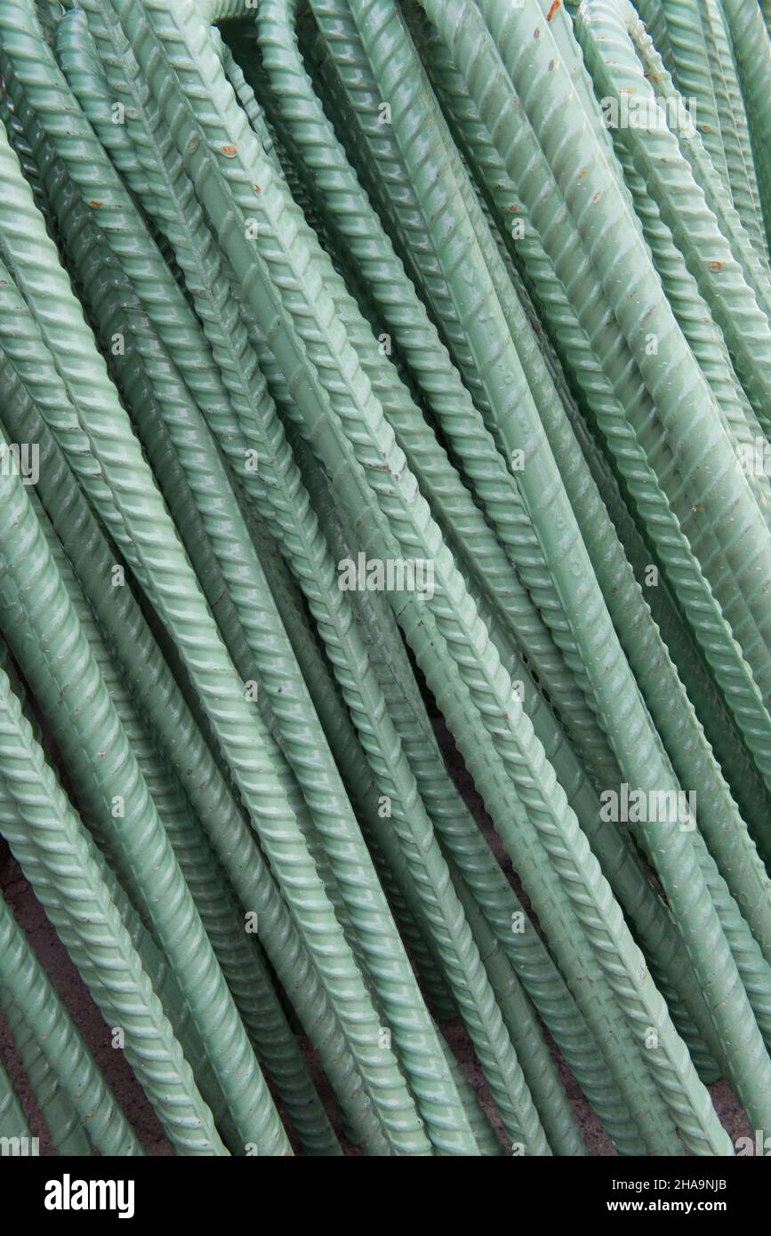A stack of pre-fabricated steel rebar treated with a corrosion resistant coating waiting to be installed at an infrastructure project. Stock Photo