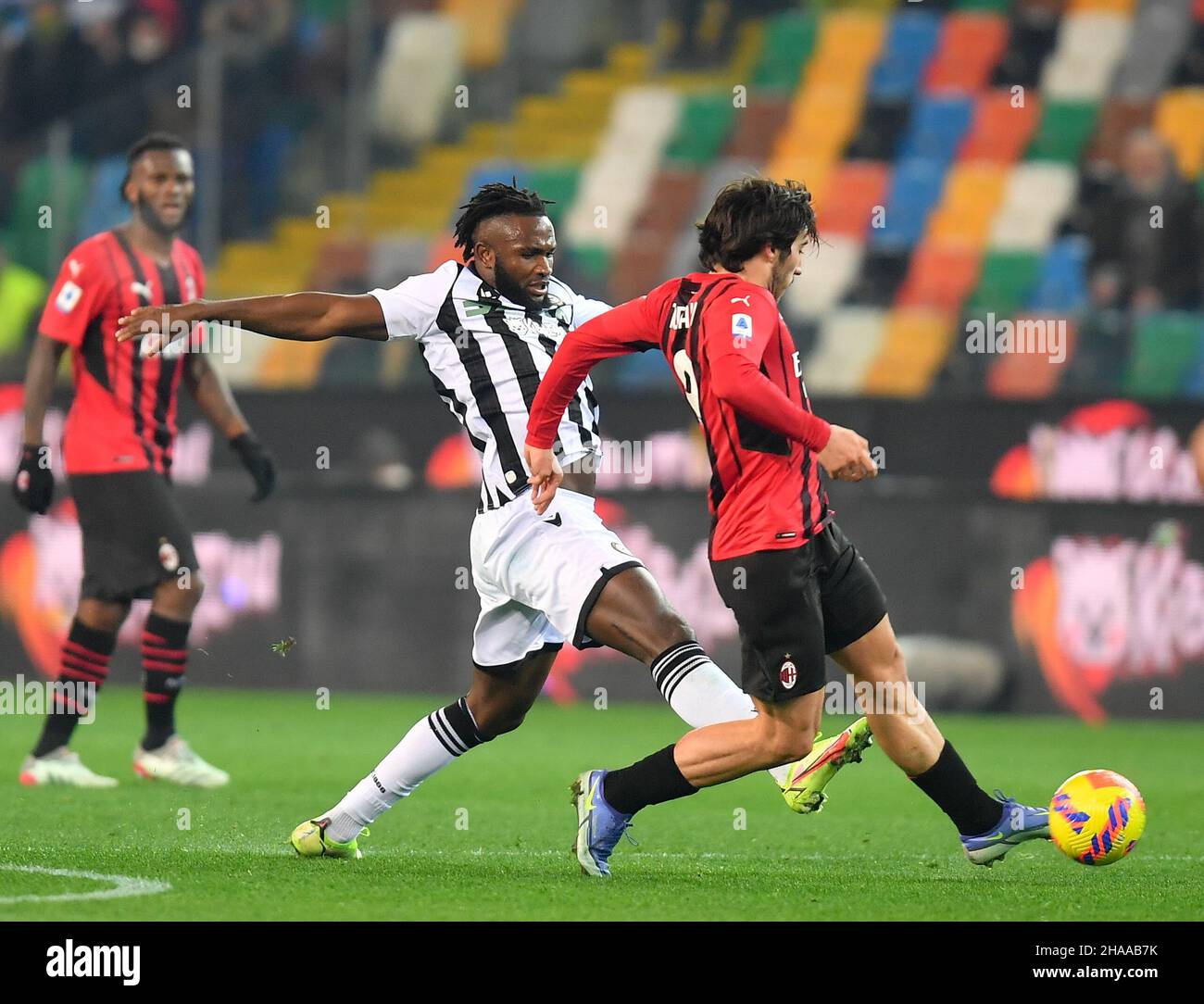 Udine, Italy. 11th Dec, 2021. AC Milan's Sandro Tonali (R) vies with Udinese's Isaac Success during a Serie A soccer match between Udinese and AC Milan in Udine, Italy, Dec. 11, 2021. Credit: Str/Xinhua/Alamy Live News Stock Photo