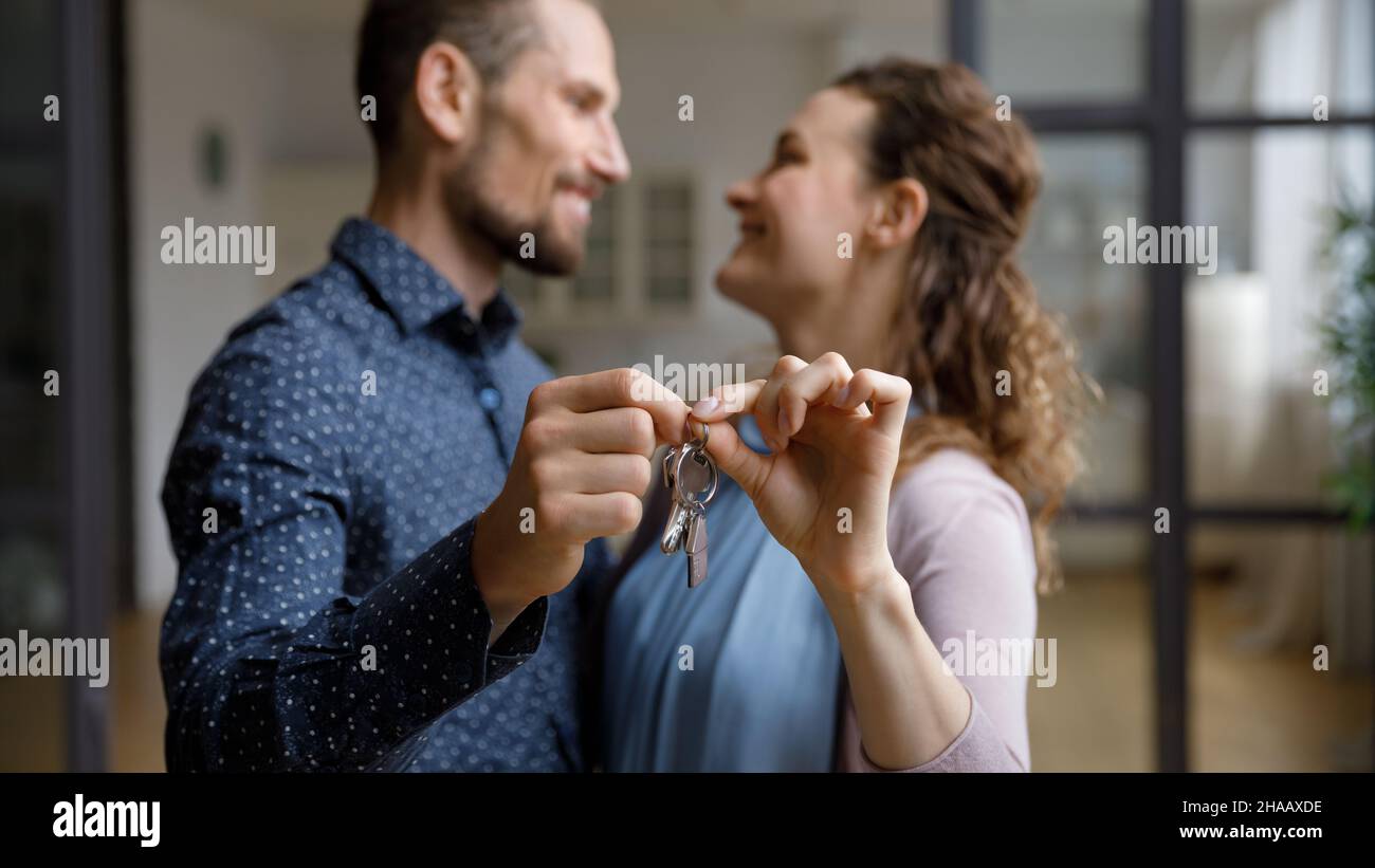 Happy cheerful young couple moving into new home Stock Photo - Alamy