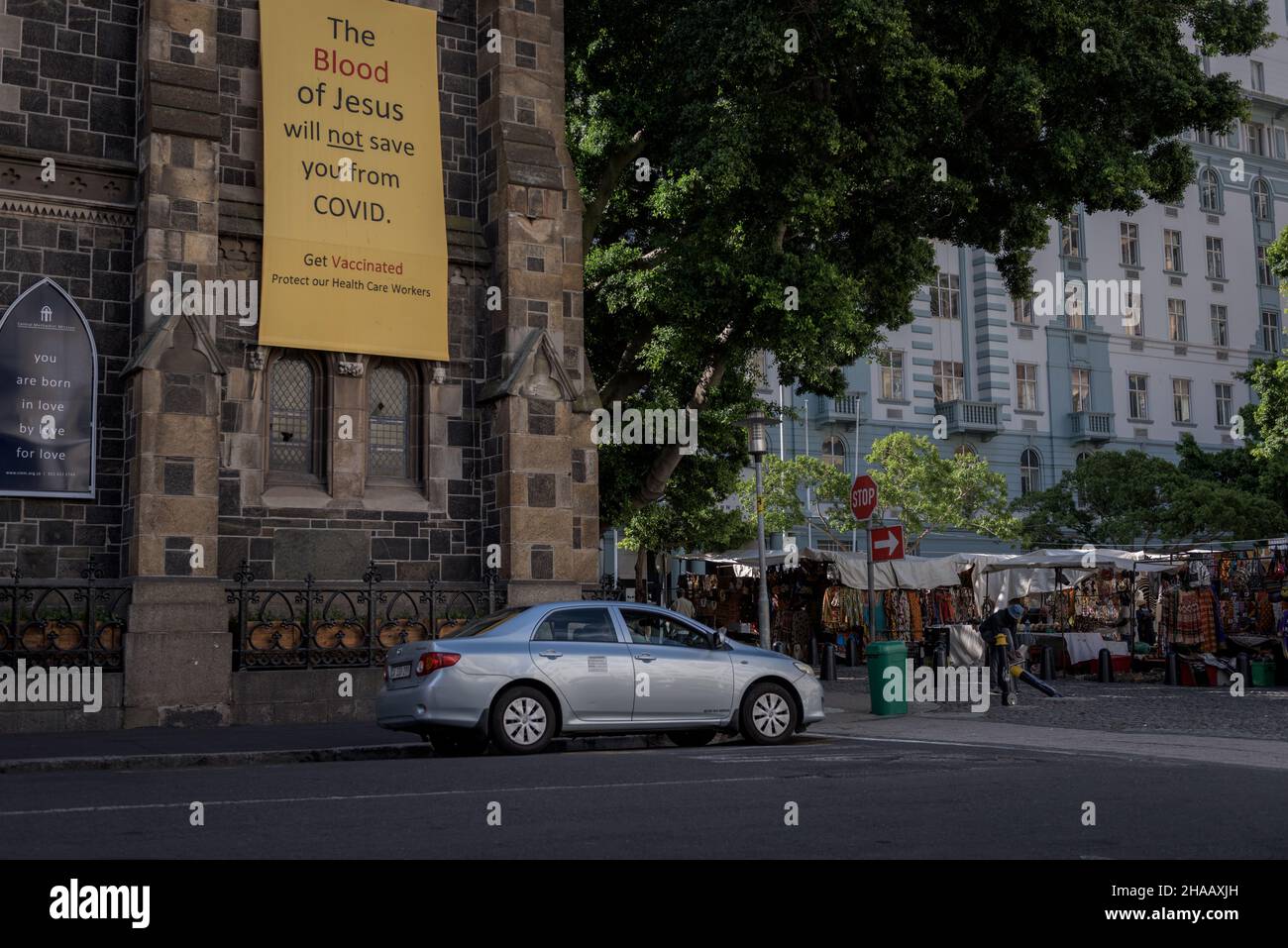 A banner draped on Cape Town's Central Methodist Church advocates  for COVID19 vaccinations and dismisses beliefs that faith can protect from disease Stock Photo