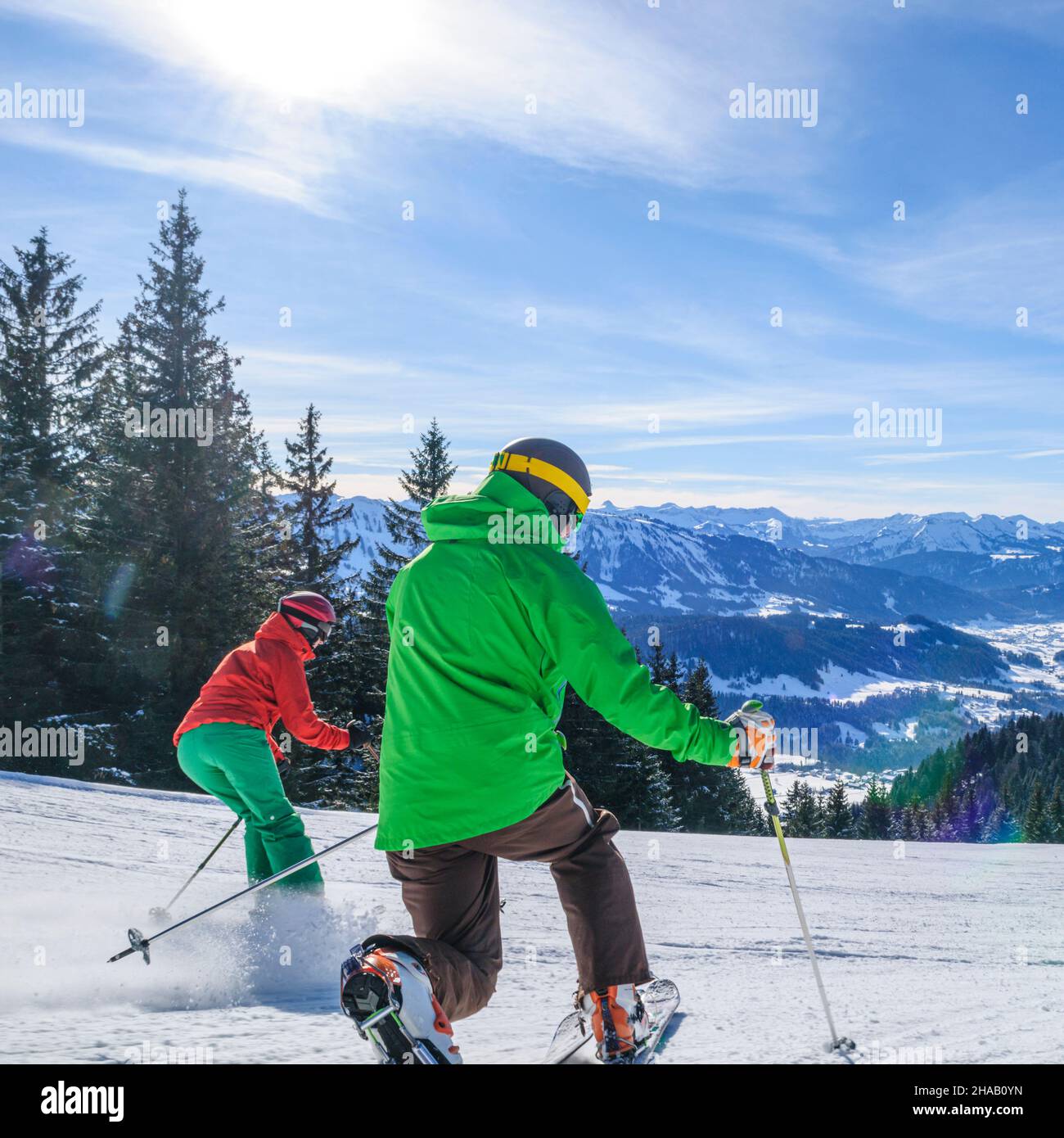 Young people skiing together on well prepared slope Stock Photo