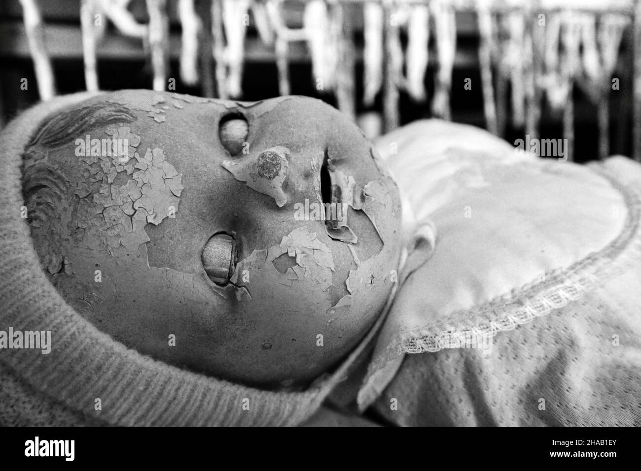 a creepy old doll in black and white Stock Photo