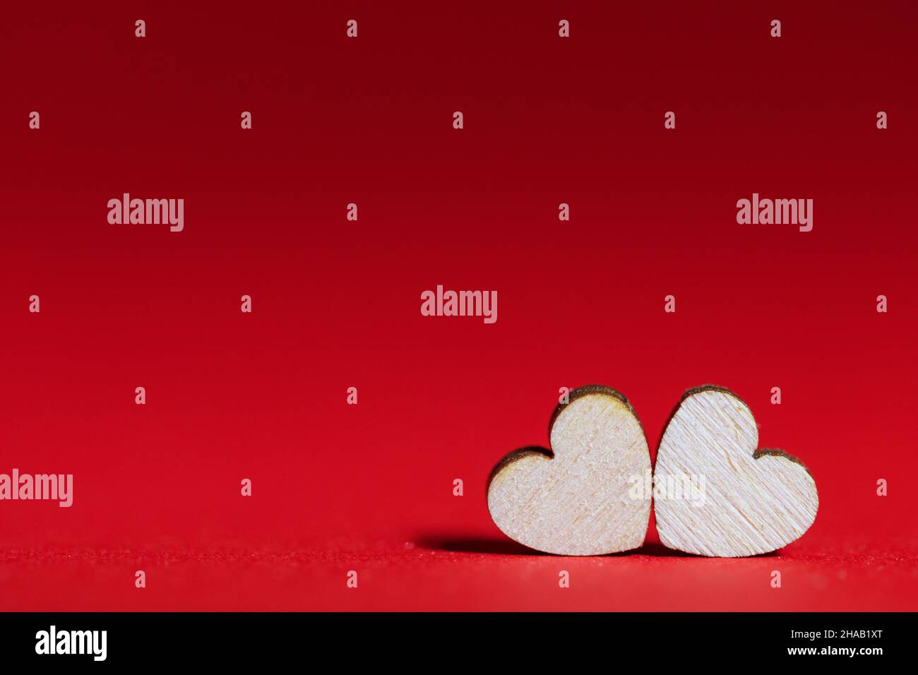 Valentines day red background with two wooden hearts Stock Photo - Alamy