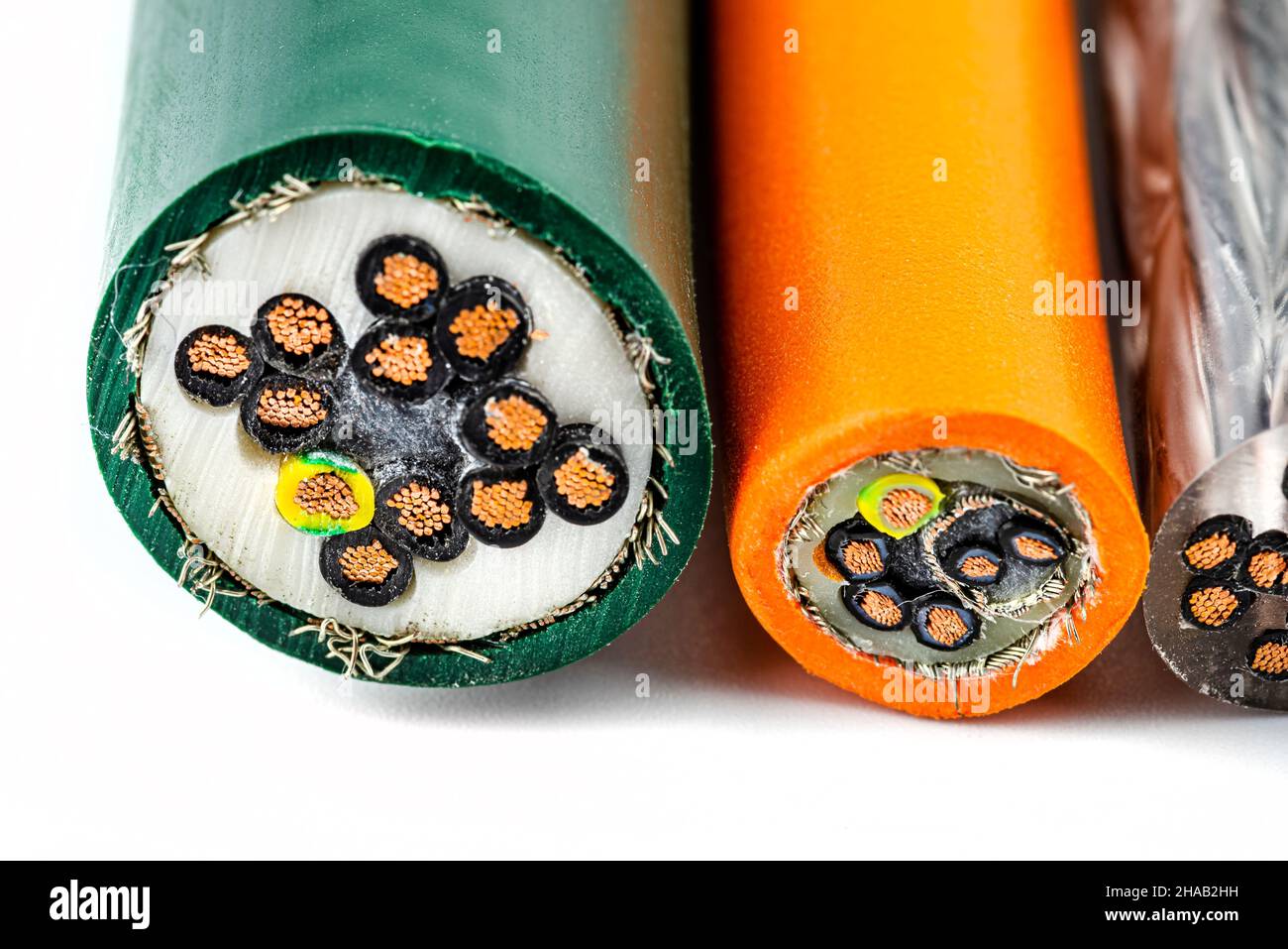 Macro photo of the cross section of various electric cables, isolated on a white background. Stock Photo