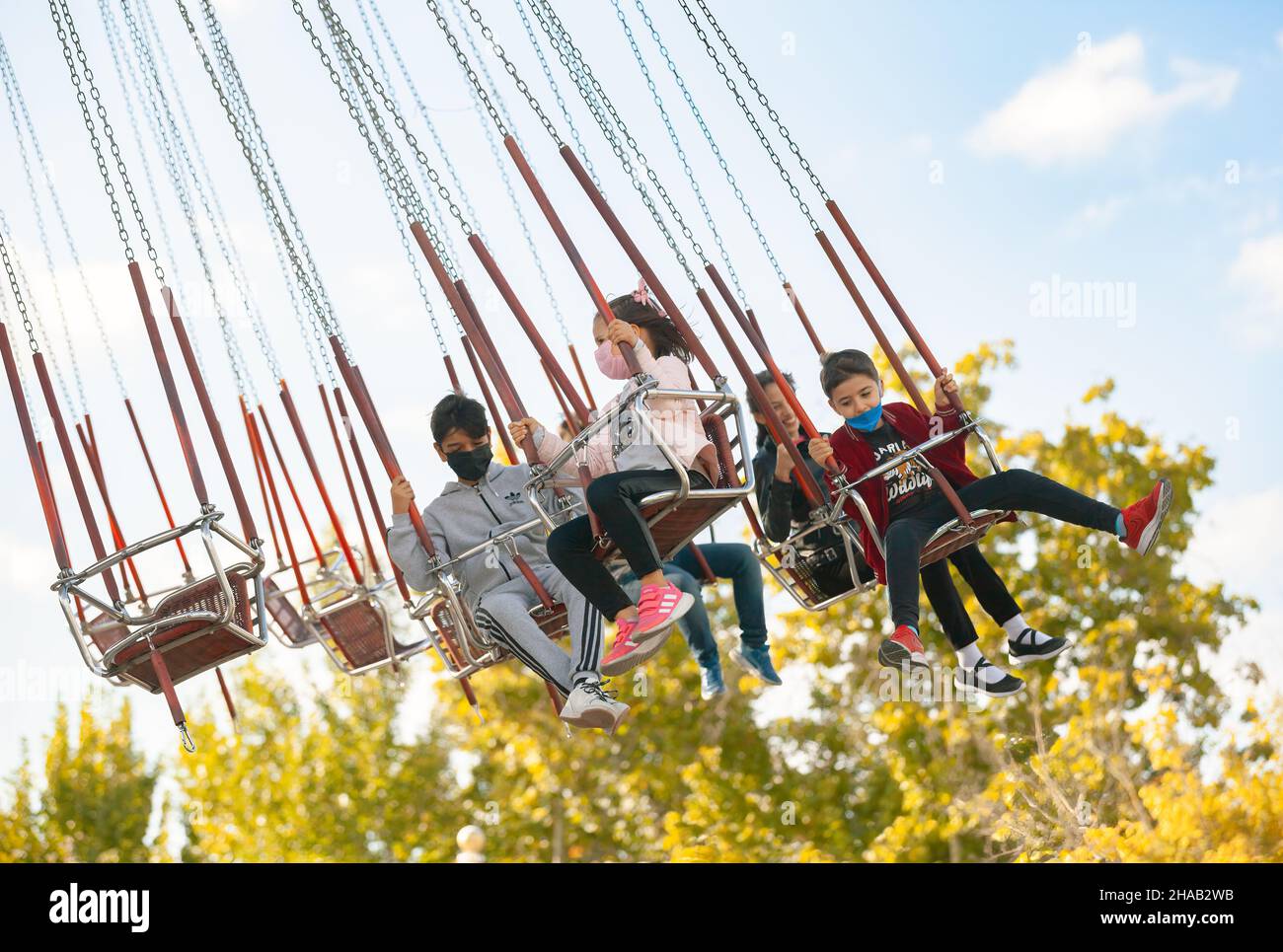 Ankara-Turkey:October 3, 2021: Children having fun on swings at luna park | Genclik Parki in Ankara. People with high adneraline entertaining at amuse Stock Photo