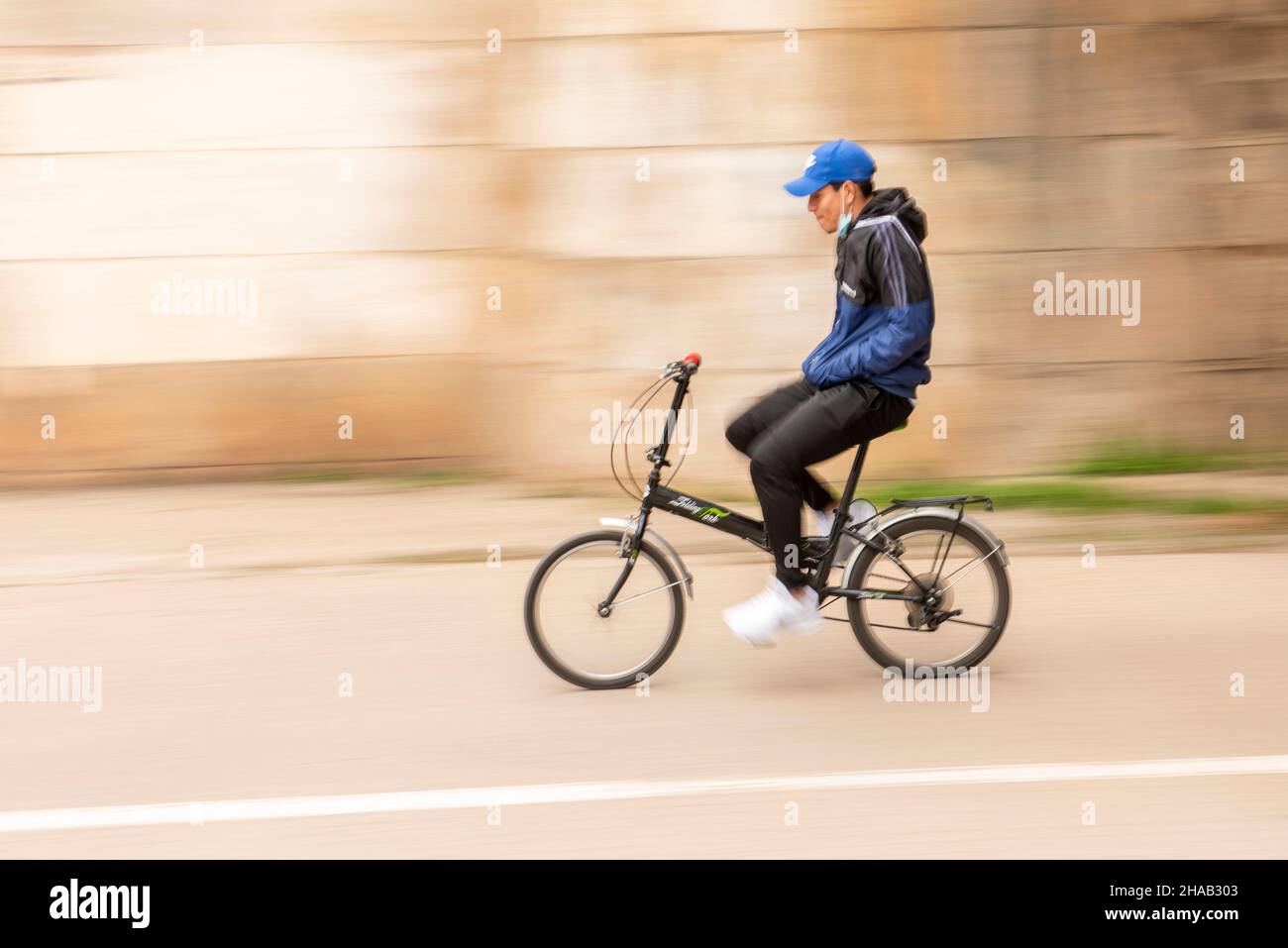 Young man on a bicycle in a city - with motion blur Stock Photo