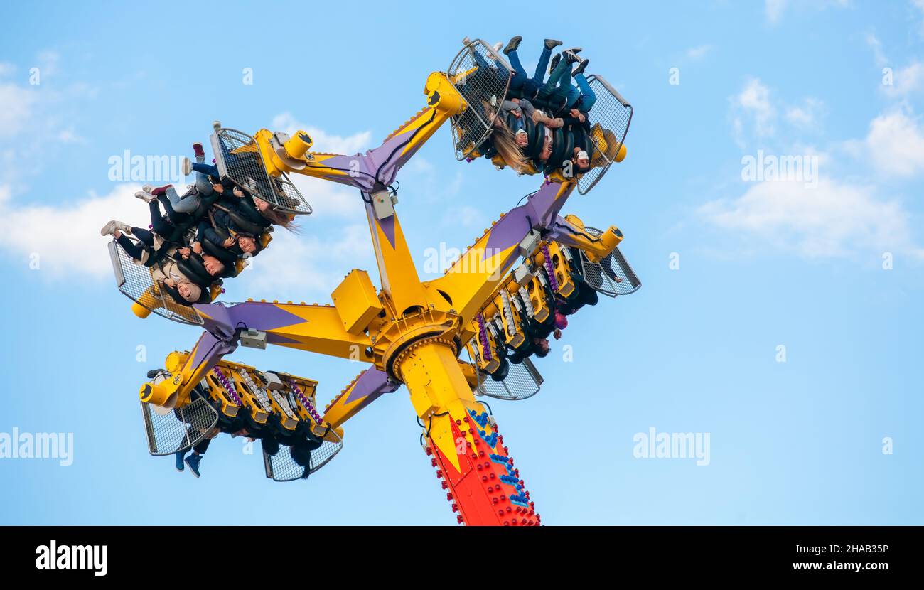 Ankara-Turkey:October 3, 2021: Group of screaming people levitating and turning in the air on a thrilling attraction at luna park | Genclik Parki in A Stock Photo