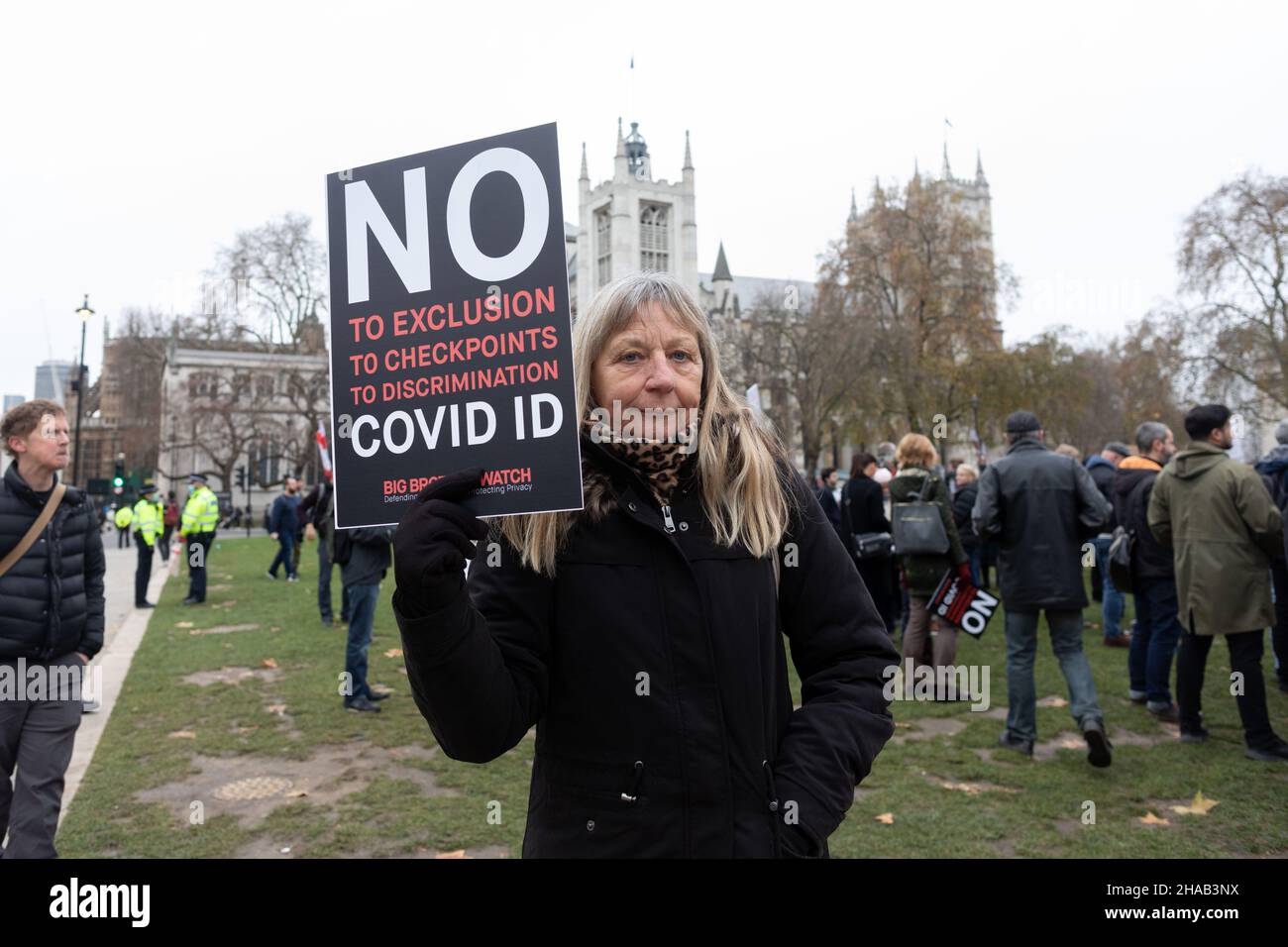 A protestor seen holding a placard that says 'no to exclusion, to checkpoints, to discrimination, covid ID' during the demonstration.Jointly led by Big Brother Watch and Migrant Organise, protestors gathered to voice discontent in relation to the UK government's attempt to make vaccine passports and other forms of COVID IDs a requisite for large scale events and entry into public spaces. The group seeks to clearly delineate the difference between anti vaccine passports specifically and anti vaccines, with which they identify with the former. (Photo by Belinda Jiao/SOPA Images/Sipa USA) Stock Photo