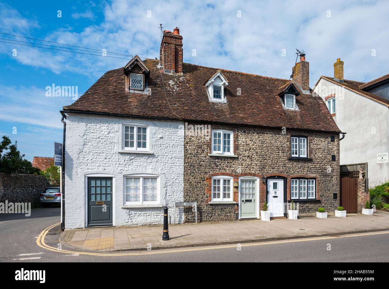 Early 19th century Grade II Listed terraced cottages with nodular flint walls & attic rooms with dormer windows in Arundel, West Sussex, England, UK. Stock Photo