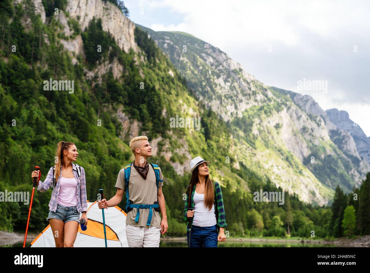 Group of friends with backpacks doing trekking excursion on mountain Stock Photo