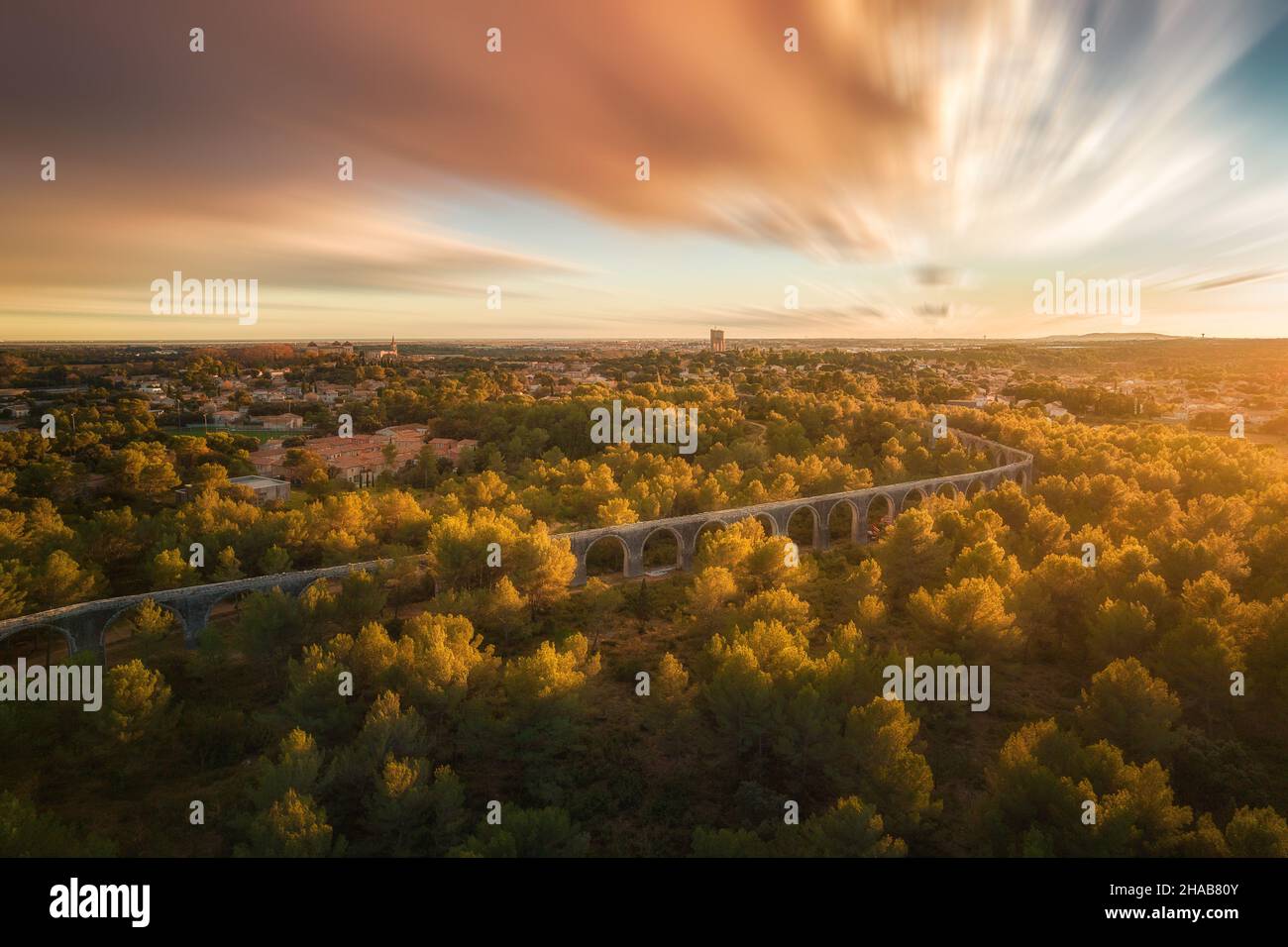 Aerial view of the ancient roman aqueduct within the forest at dusk in ...