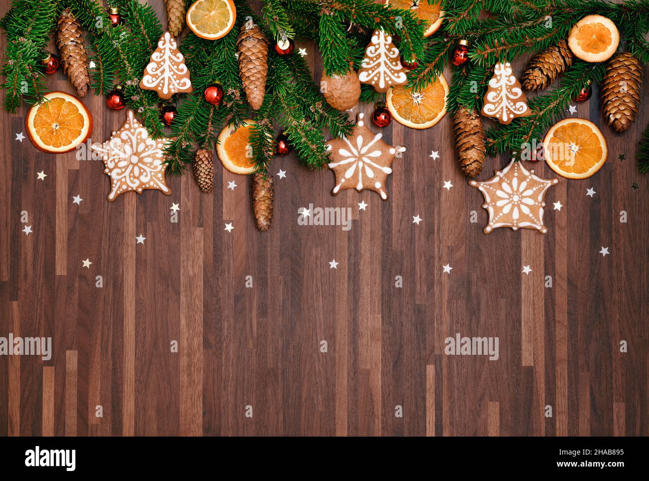 Christmas background with fir tree and decoration. Wooden natural decoration ornament wide horizontal banner with copyspace. Ginger cookies and spruce Stock Photo