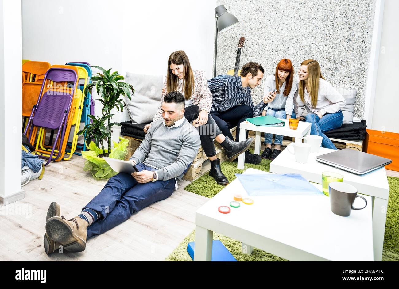 Young people employee workers having break in start up office - Human resources business concept with creative entrepreneurs having fun together Stock Photo