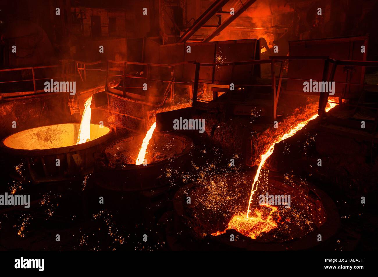 A jet of molten steel is poured into ladles. Metallurgical industry ...