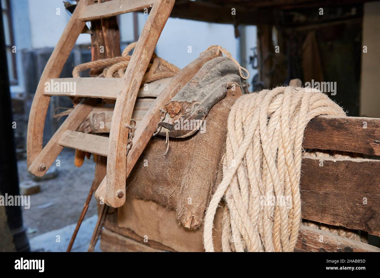 hemp rope coiled on old wooden boards in a farmhouse interior Stock Photo