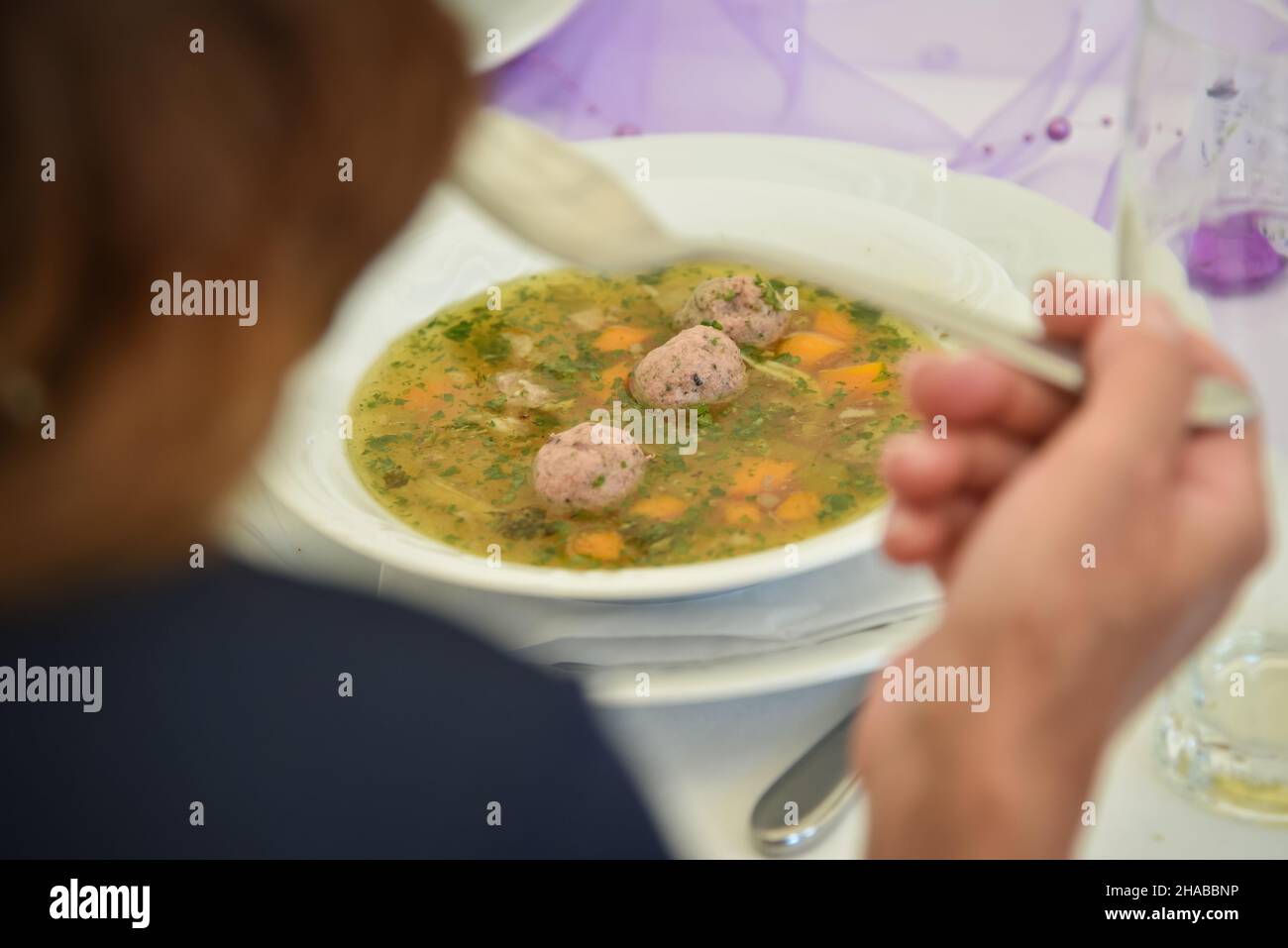 A plate of liver dumpling soup with chives Stock Photo