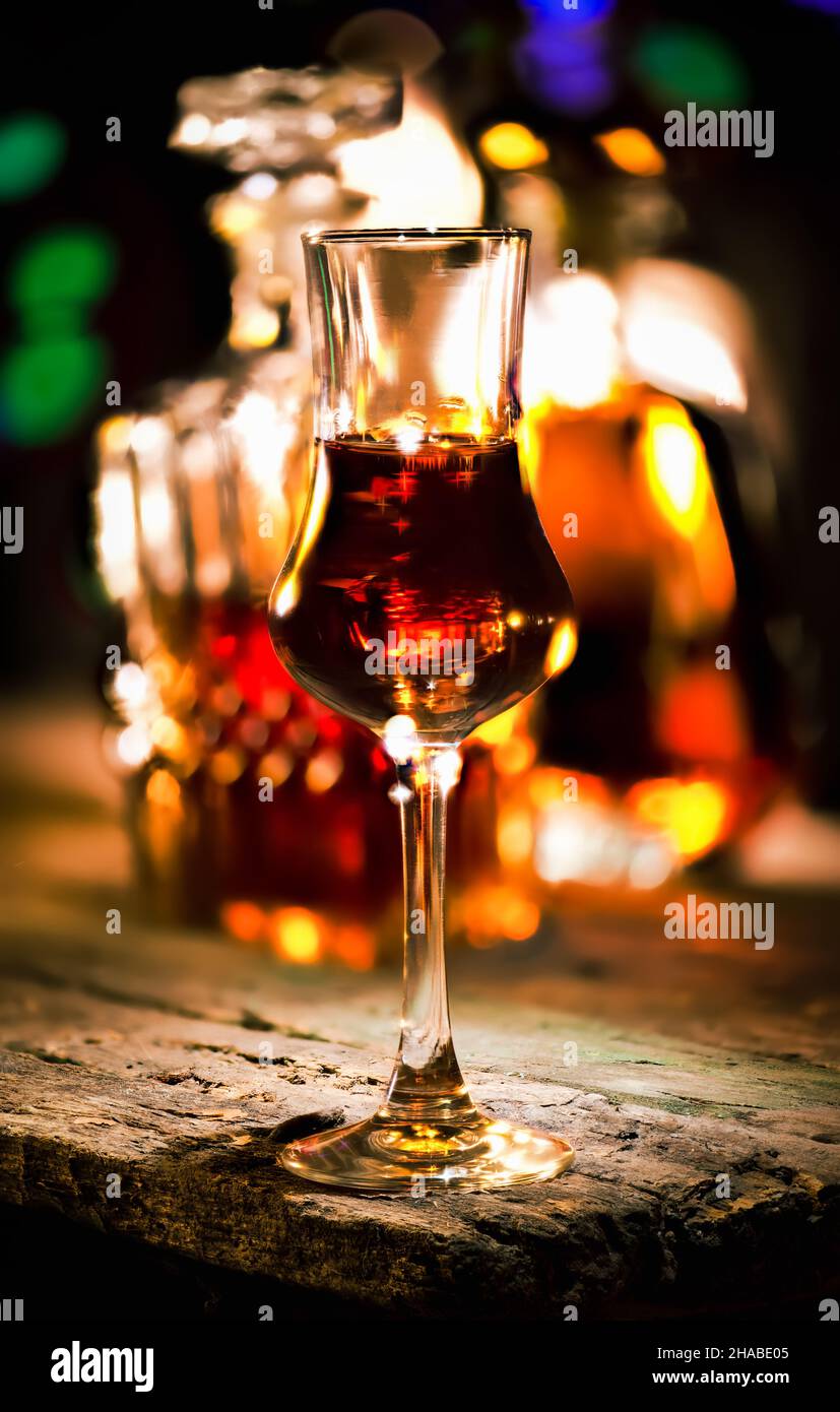 Brandy in a glass on a wooden table Stock Photo