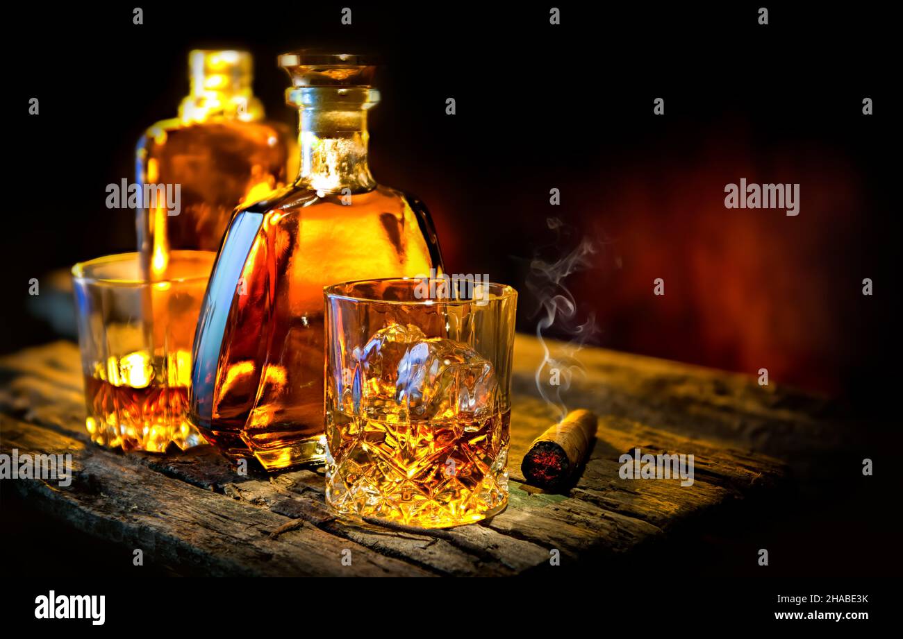 Glass and bottle of whiskey on a wooden table Stock Photo