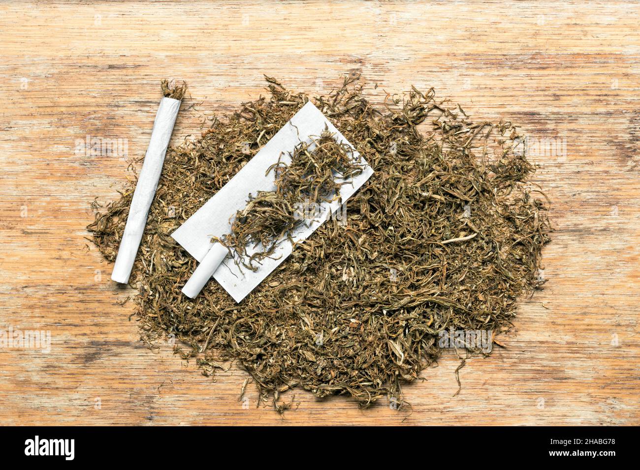 Rolling tobacco on wooden background Stock Photo