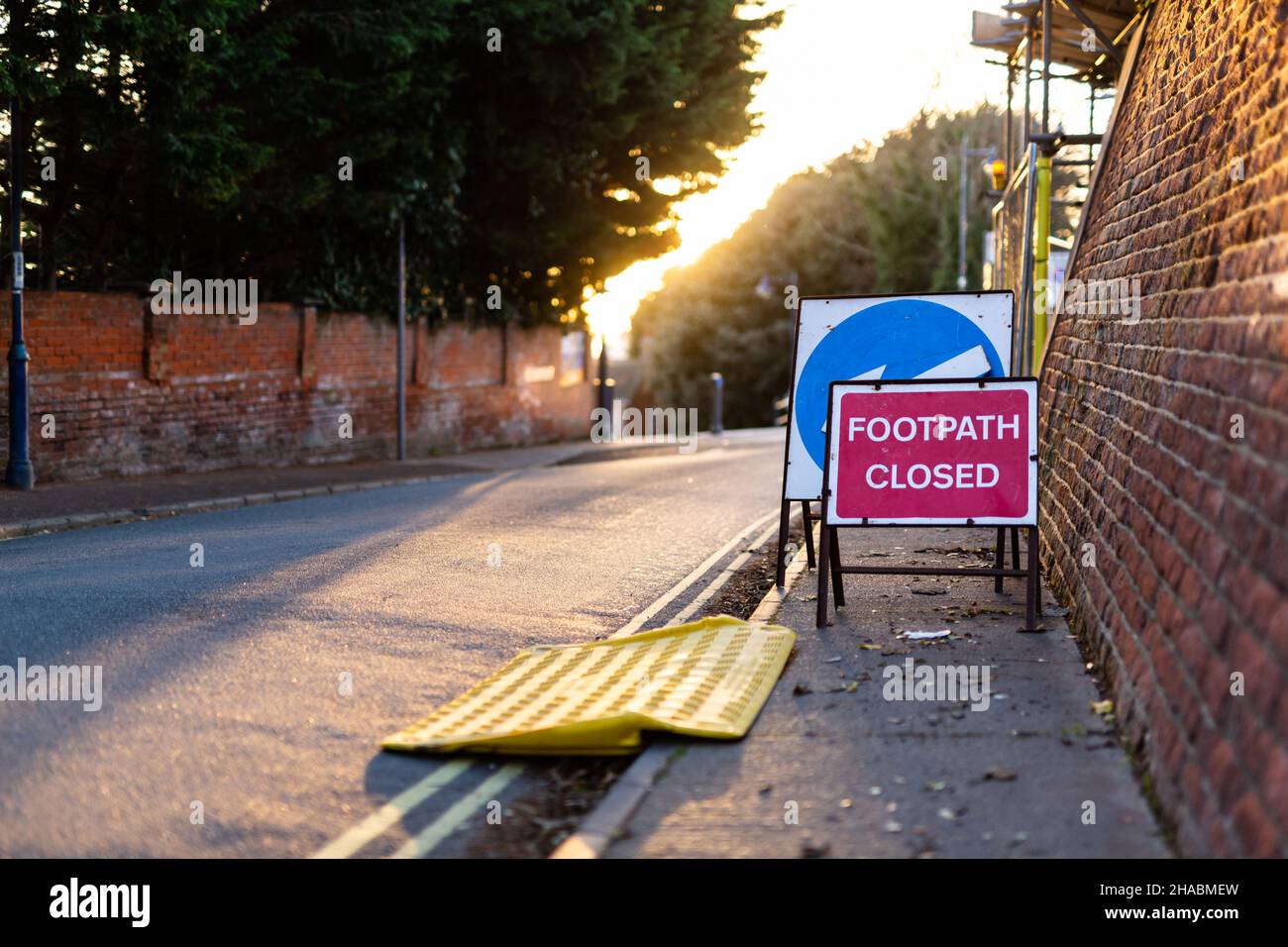 'Footpath Closed' sign and a temporary wheelchair ramp informing the public of the closure ahead Stock Photo