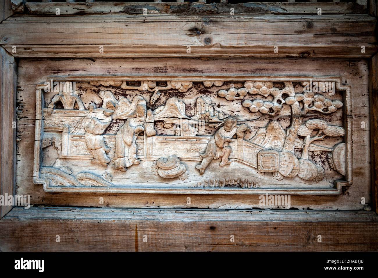 Close-up detail of ancient classic wooden door panel decorated with typical Chinese architecture style pattern and woodcarving Stock Photo