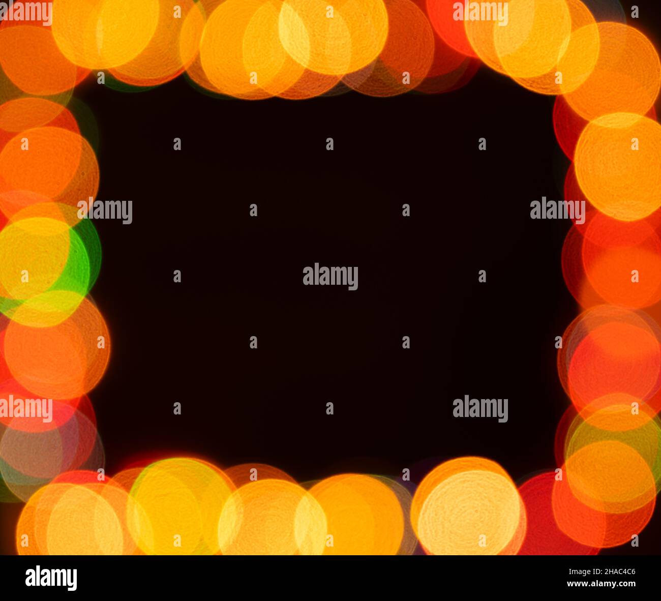 Blurred christmas lights frame on dark background Stock Photo