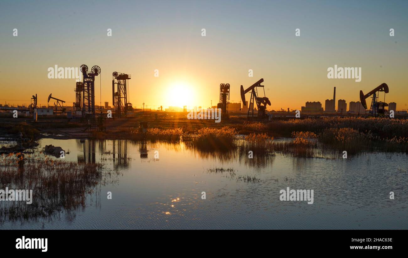 Tangshan. 12th Dec, 2021. Photo taken on Dec. 12, 2021 shows the morning view of Jidong Oilfield in north China's Hebei Province. Since entering winter, workers at Jidong Oilfield have overcome the unfavorable factors of winter production and strengthened daily inspection to ensure the completion of annual production targets. Credit: Liu Mancang/Xinhua/Alamy Live News Stock Photo