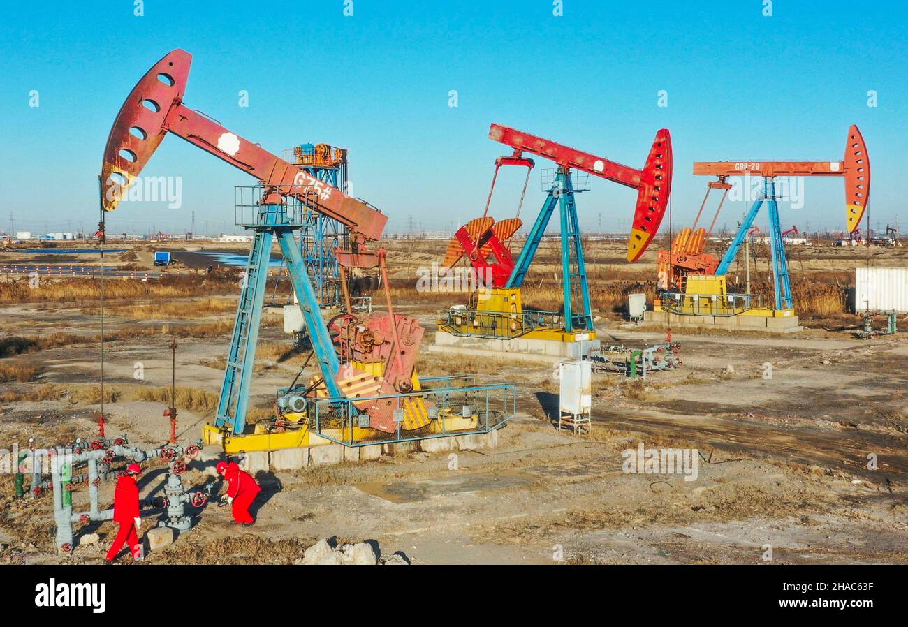 Tangshan. 12th Dec, 2021. Aerial photo taken on Dec. 12, 2021 shows workers inspecting an oil well at Jidong Oilfield in north China's Hebei Province. Since entering winter, workers at Jidong Oilfield have overcome the unfavorable factors of winter production and strengthened daily inspection to ensure the completion of annual production targets. Credit: Liu Mancang/Xinhua/Alamy Live News Stock Photo