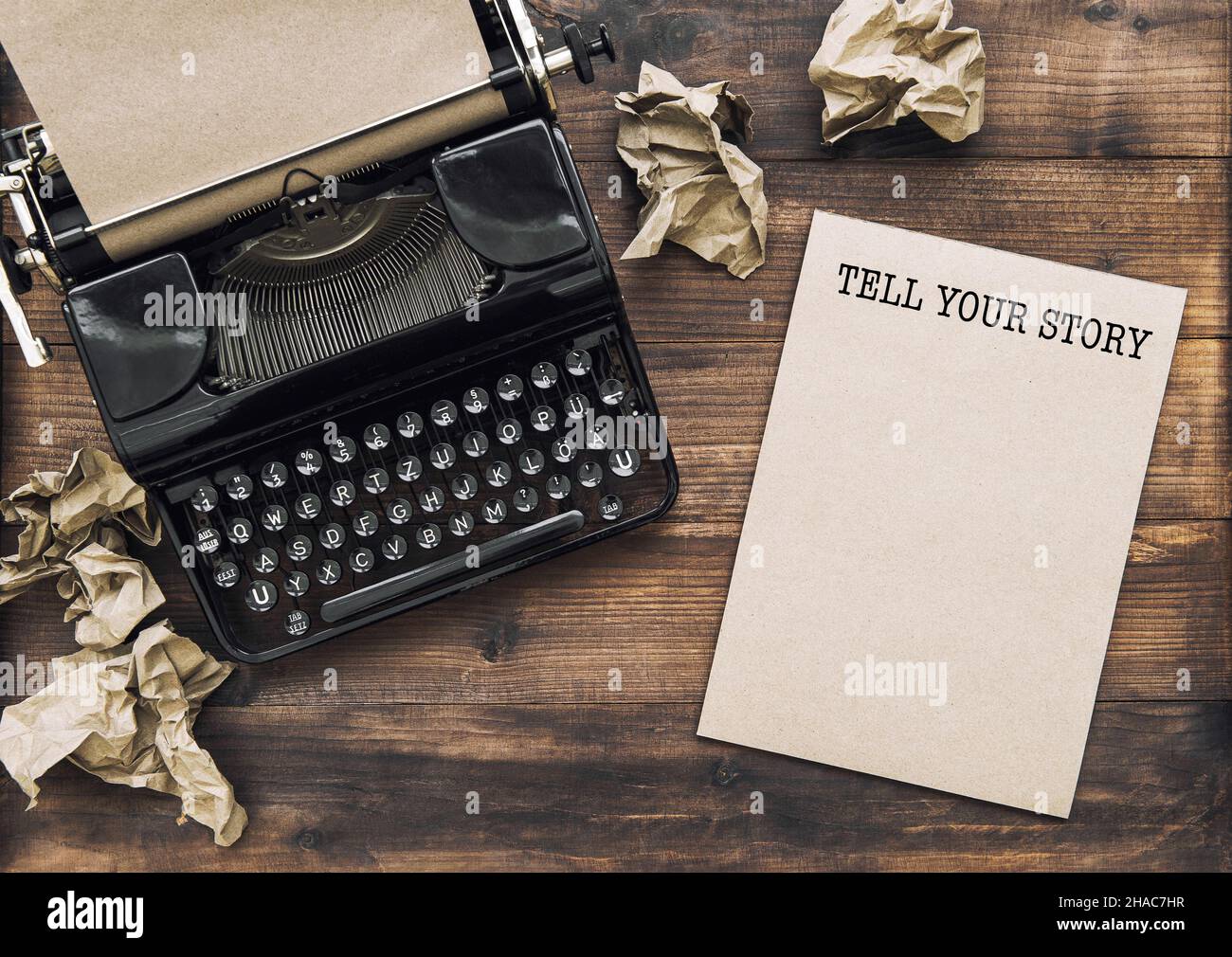 Antique typewriter and paper notebook. Tell Your Story. Creativity concept Stock Photo