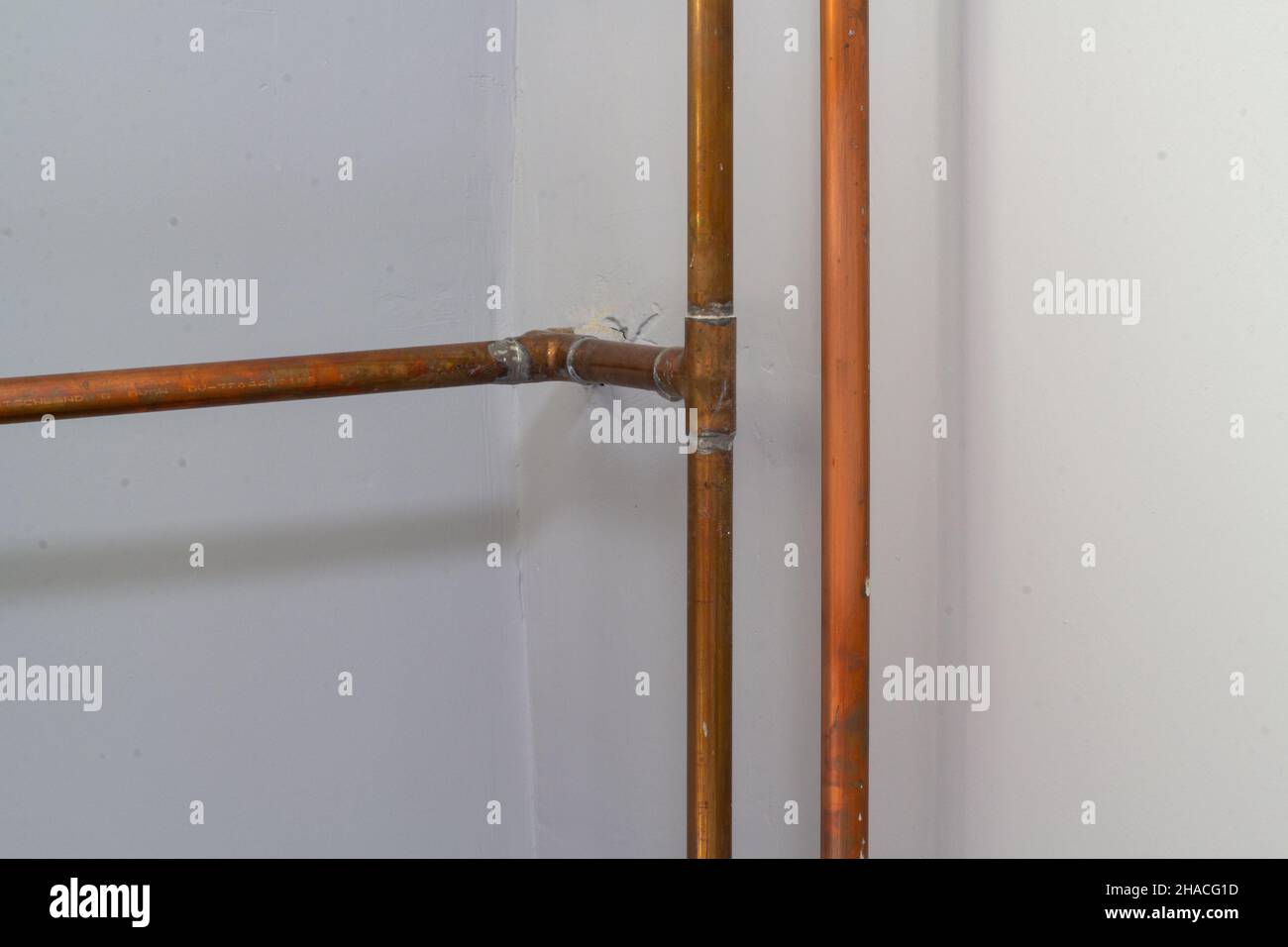 The copper pipes against a wall Stock Photo Alamy