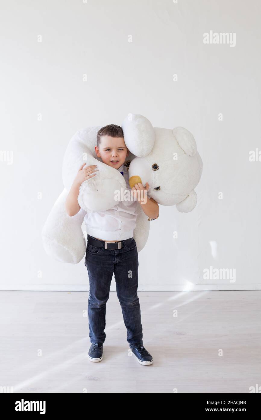 beautiful boy with toy teddy bear on white Stock Photo - Alamy