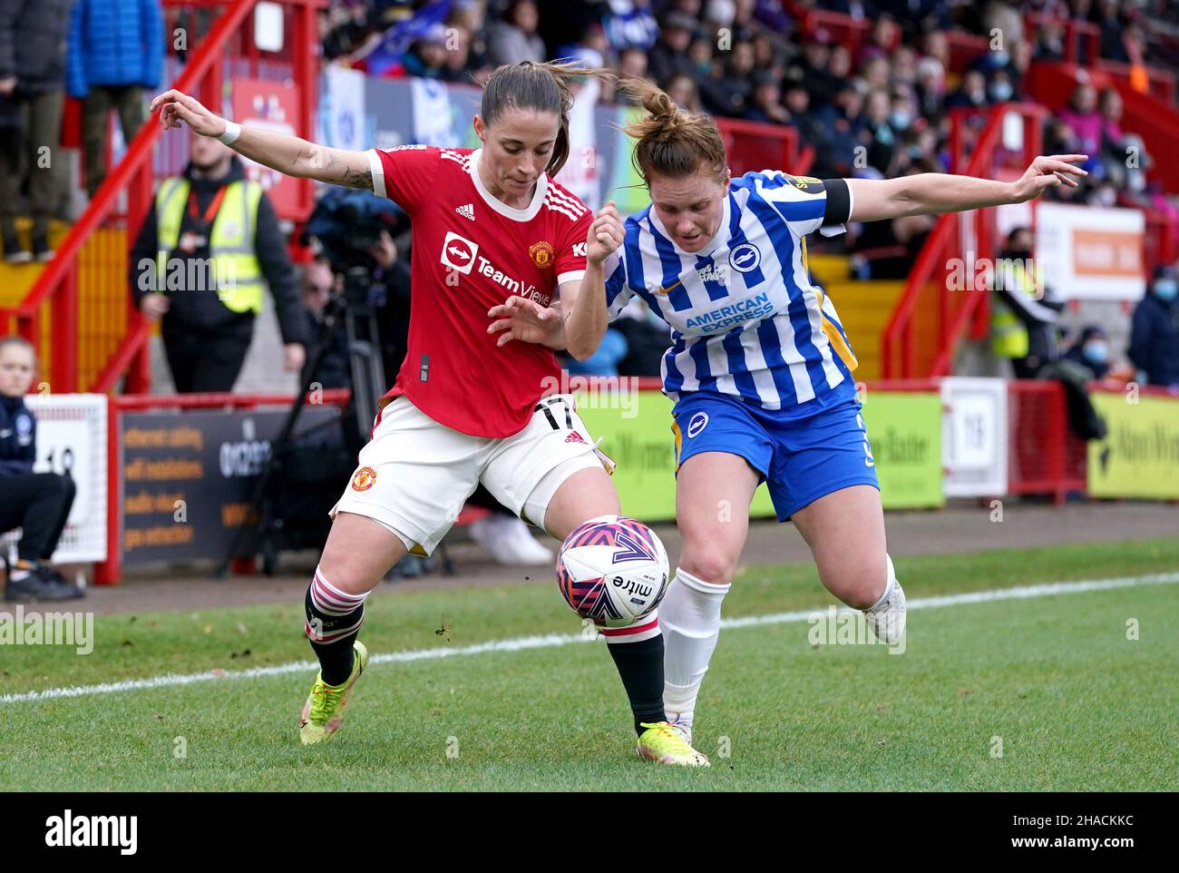 Manchester United's Ona Batlle (left) and Brighton and Hove Albion's Felicity Gibbons battle for the ball during the Barclays FA Women's Super League match at The People's Pension Stadium, Brighton. Picture date: Sunday December 12, 2021. Stock Photo