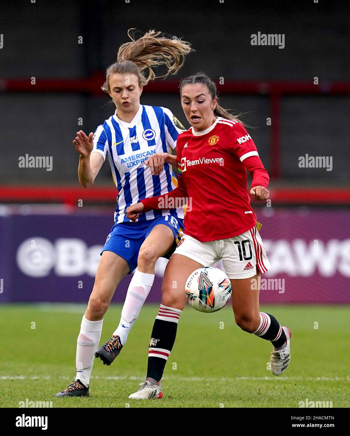 Manchester United's Katie Zelem (right) and Brighton and Hove Albion's Ellie Brazil battle for the ball during the Barclays FA Women's Super League match at The People's Pension Stadium, Brighton. Picture date: Sunday December 12, 2021. Stock Photo