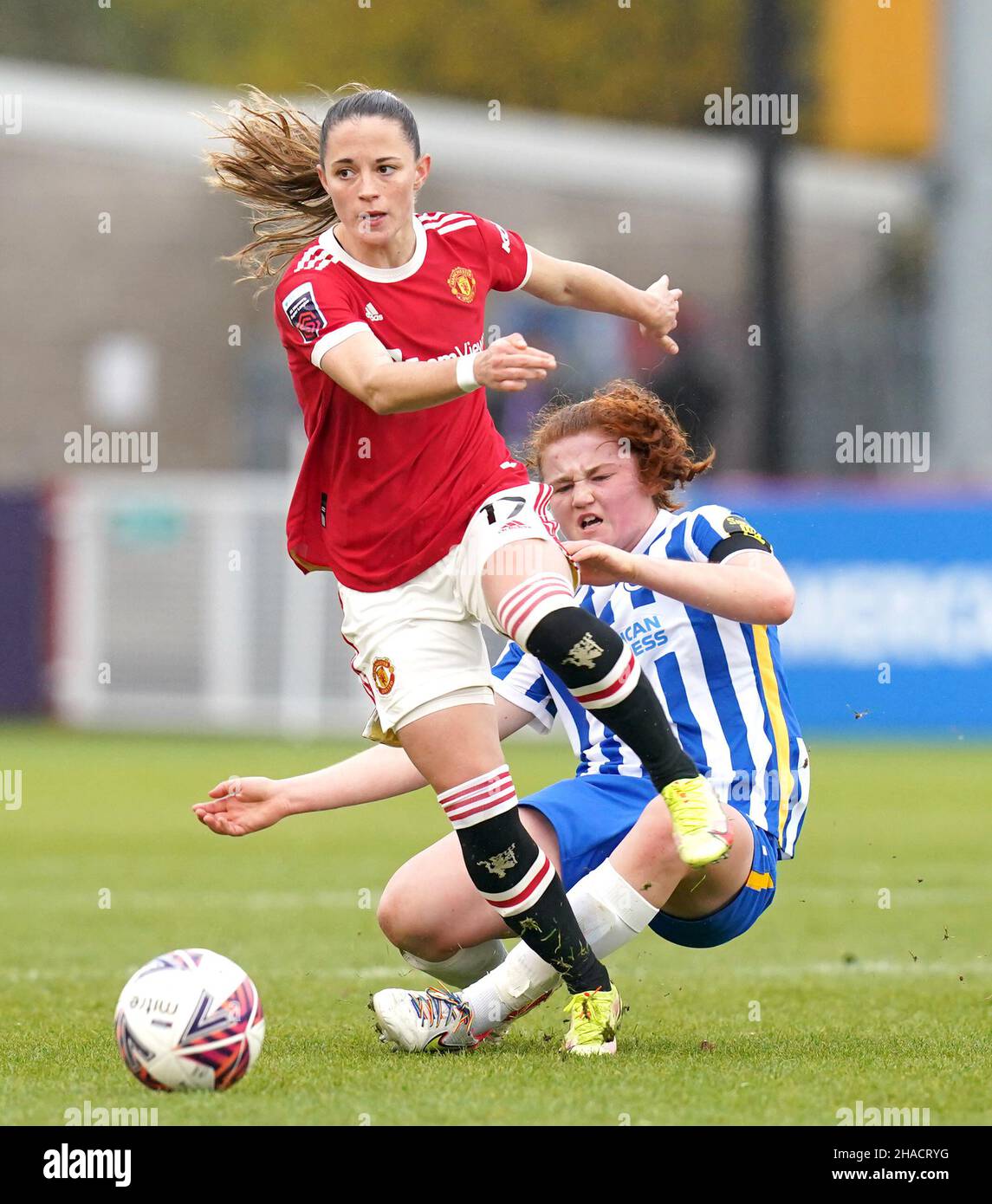 Manchester United's Ona Batlle (front) and Brighton and Hove Albion's Libby Bance battle for the ball during the Barclays FA Women's Super League match at The People's Pension Stadium, Brighton. Picture date: Sunday December 12, 2021. Stock Photo