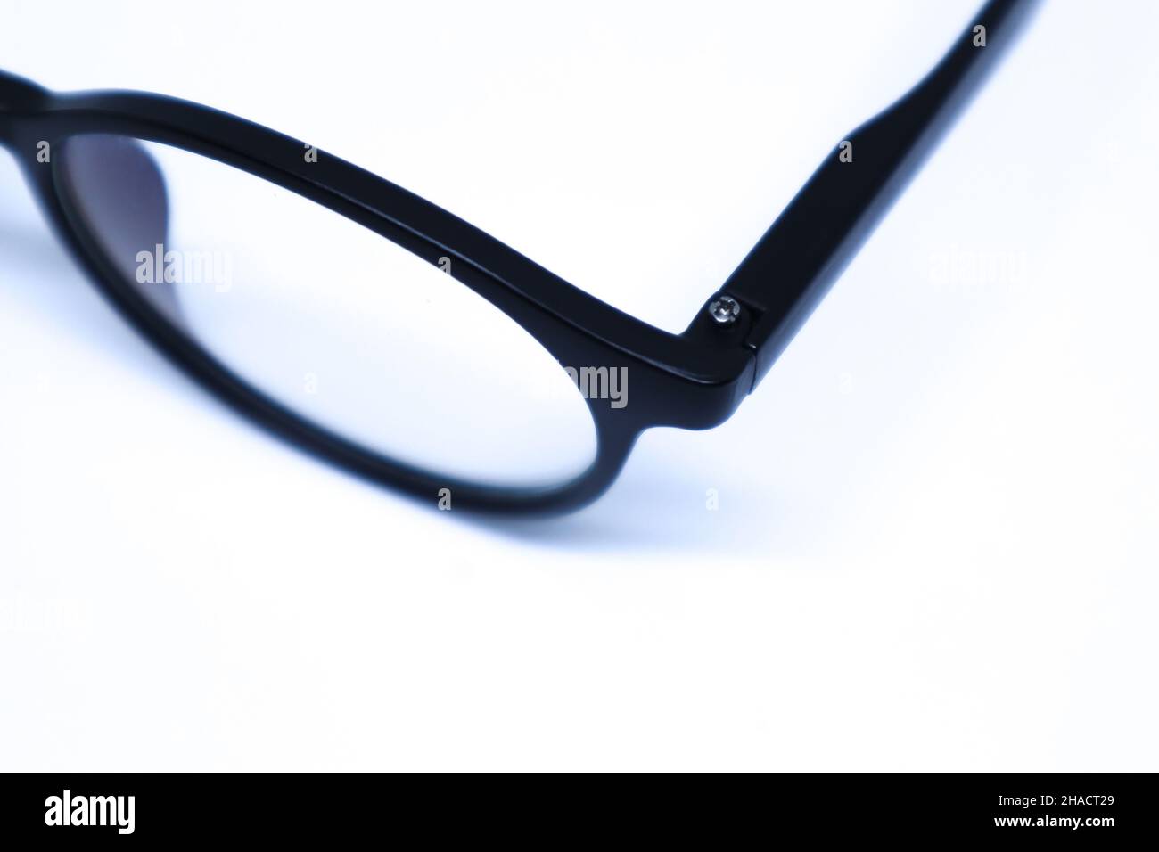 Detail of Black Eyeglasses in The White Background with Oblique Top Shot, Landscape Mode and Minimalist Stock Photo