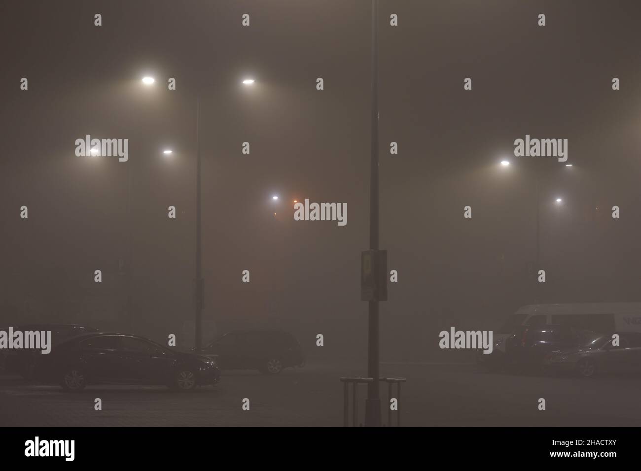 Fog in the city in the evening illuminated by street lamps. Night. Stock Photo