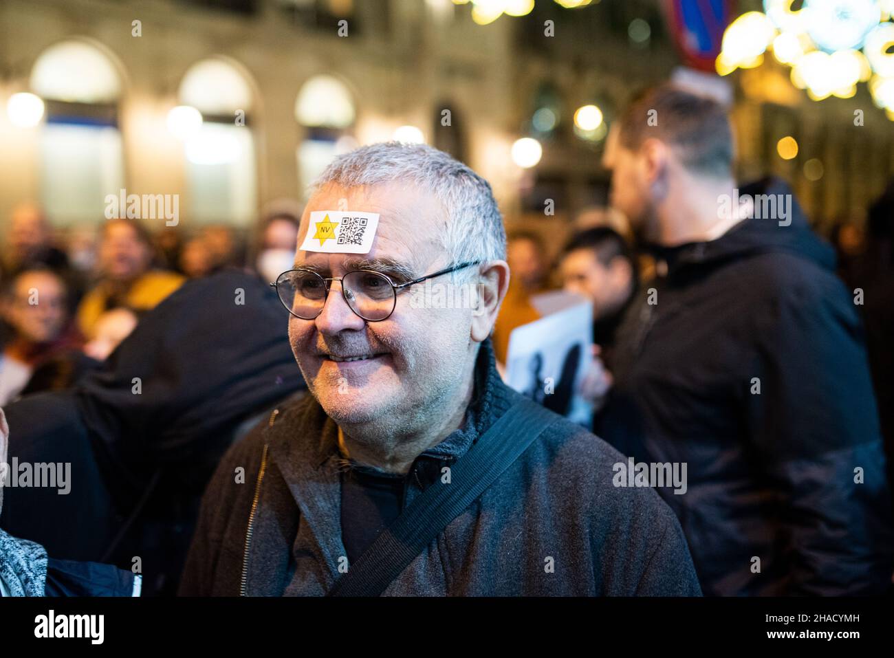 Spain. 11th Dec, 2021. A man wears a yellow star, know as Jewish Badge, with a qr code on it, during a demonstration of the antivax movement against the Covid vaccines and the Covid vaccination certificate known as Green Pass in the Barcelona city center in Spain on December 11, 2021. The Covid-19 passport is known required for access to bars and restaurants in Catalonia and other regions of Spain. (Photo by Davide Bonaldo/Sipa USA) Credit: Sipa USA/Alamy Live News Stock Photo