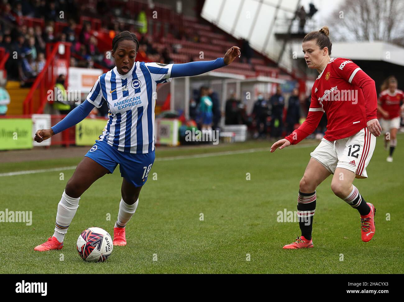 Crawley, UK. 12th Dec, 2021. Danielle Carter of Brighton and Hove Albion and Hayley Ladd of Manchester United challenge for the ball during the The FA Women's Super League match at The People's Pension Stadium, Crawley. Picture credit should read: Paul Terry/Sportimage Credit: Sportimage/Alamy Live News Stock Photo