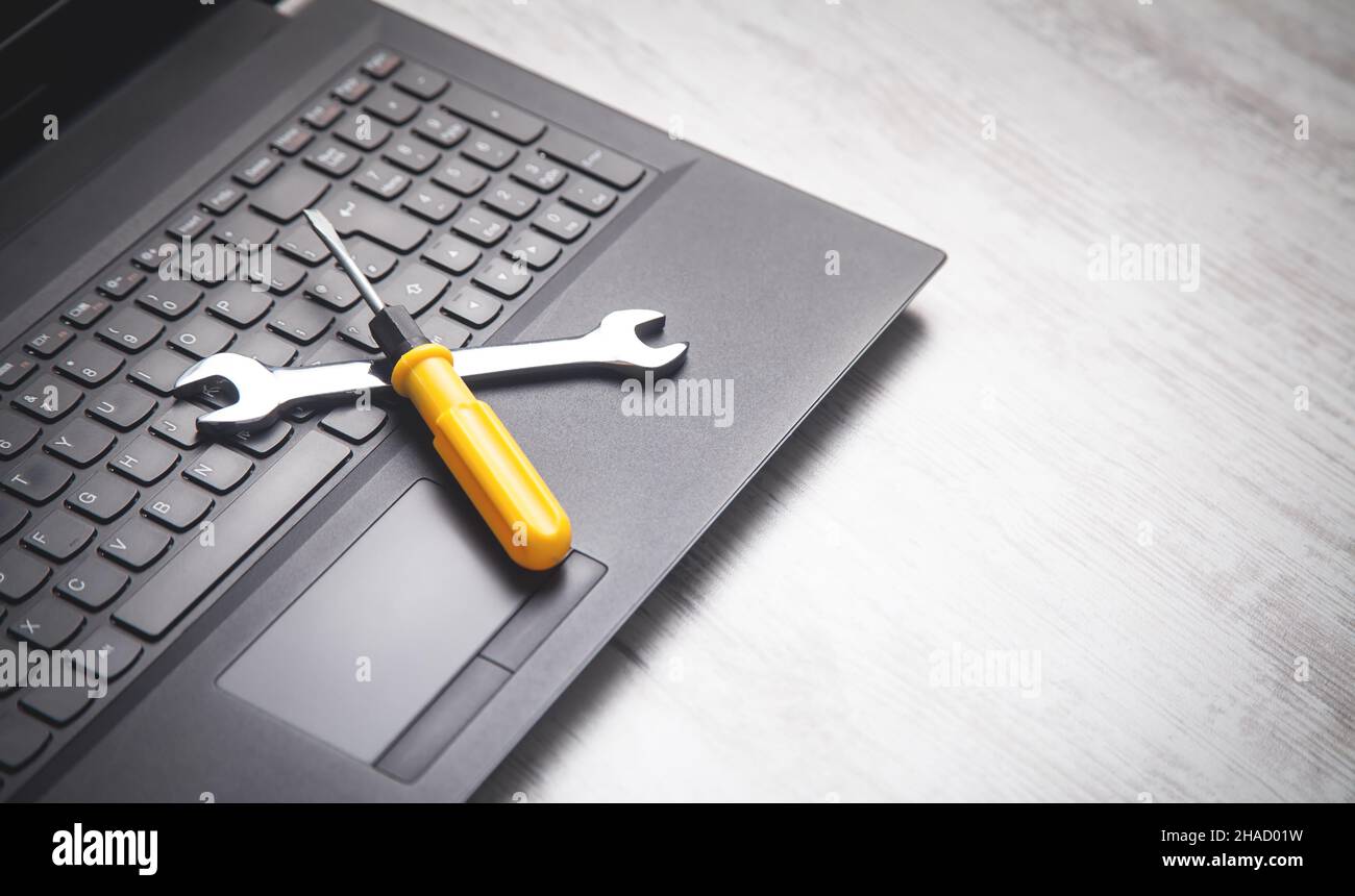 Wrench and screwdriver on the computer keyboard. IT Service. Support Stock Photo