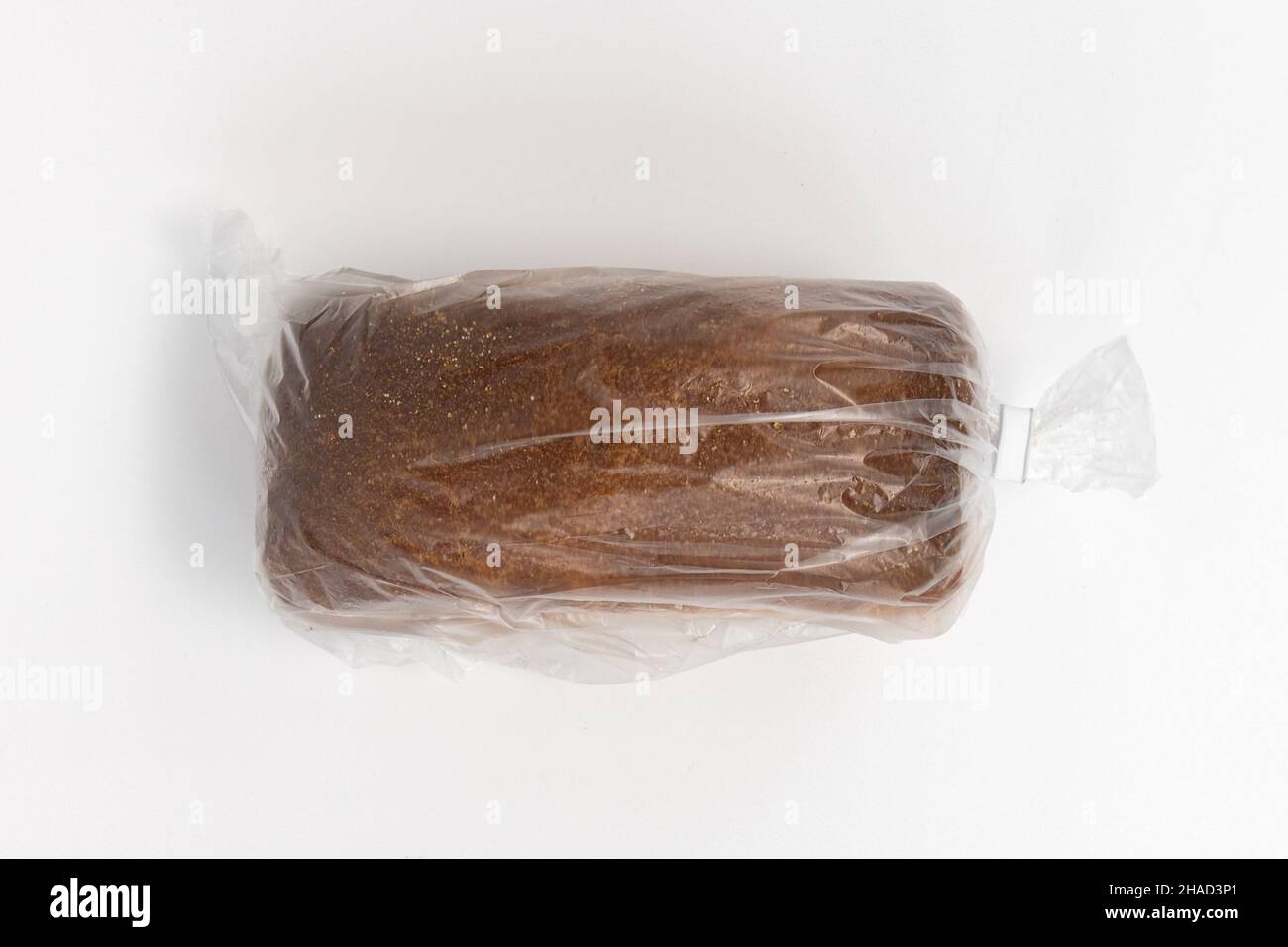 bread in plastic bag, whole loaf in transparent package isolated on white background, top view Stock Photo