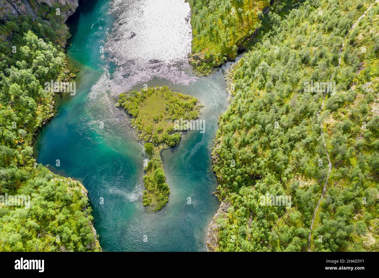 Aerial view of an island in a turquoise colored river surrounded by birch forest, valley Aurlandsdalen, Norway Stock Photo