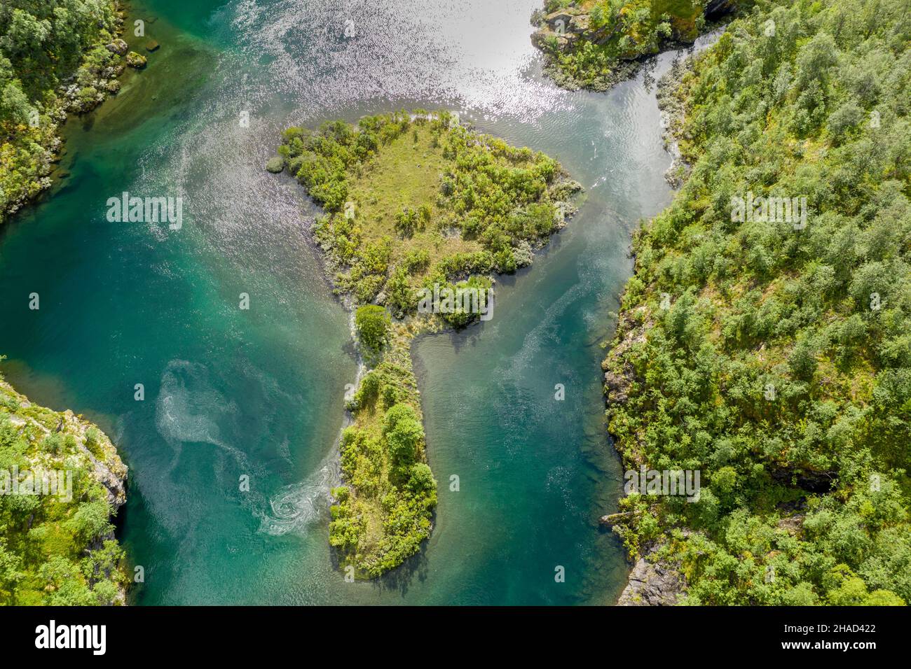 Aerial view of an island in a turquoise colored river surrounded by birch forest, valley Aurlandsdalen, Norway Stock Photo