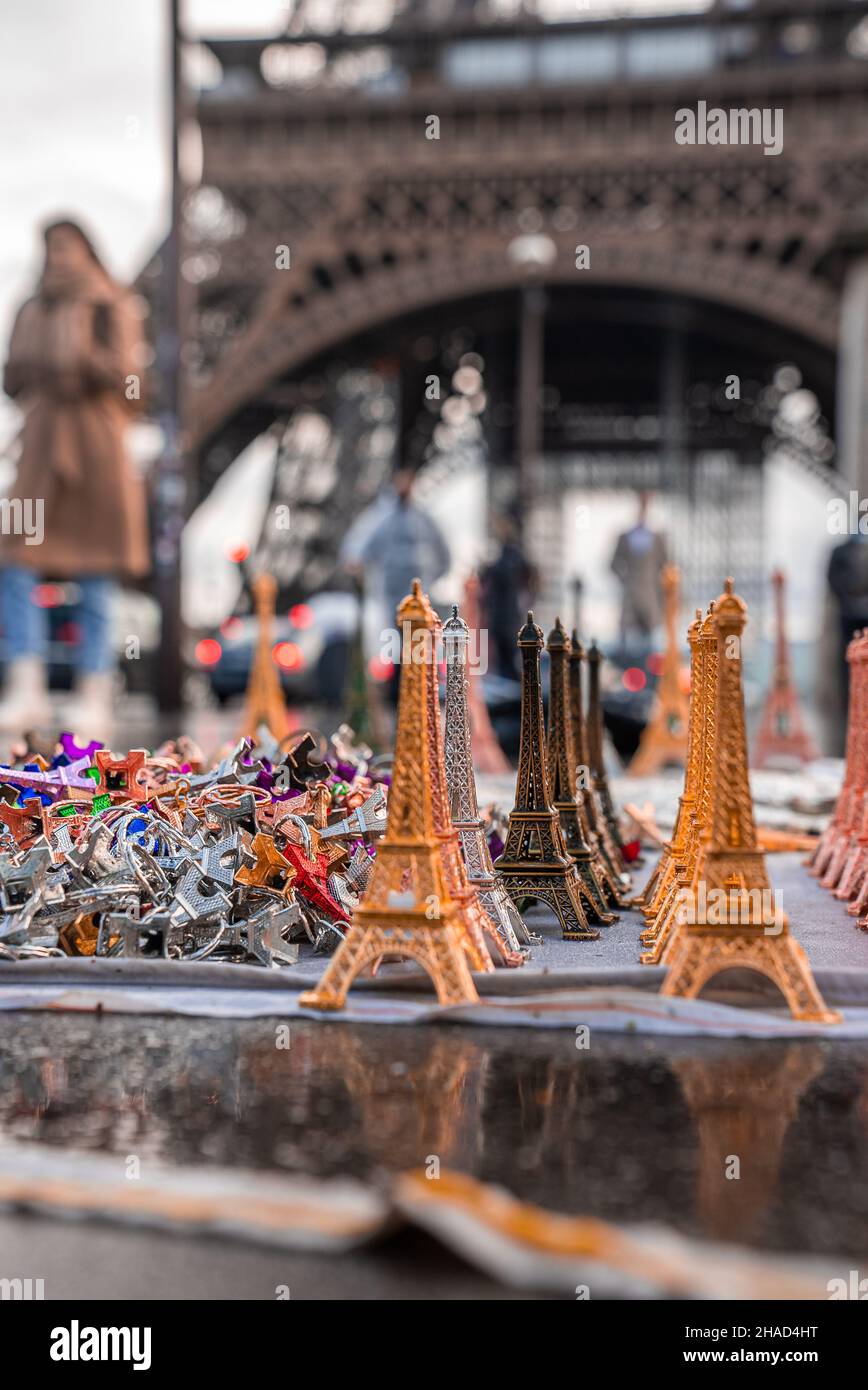 Eiffel tower souvenirs with a real Eiffel tower in the background. Stock Photo
