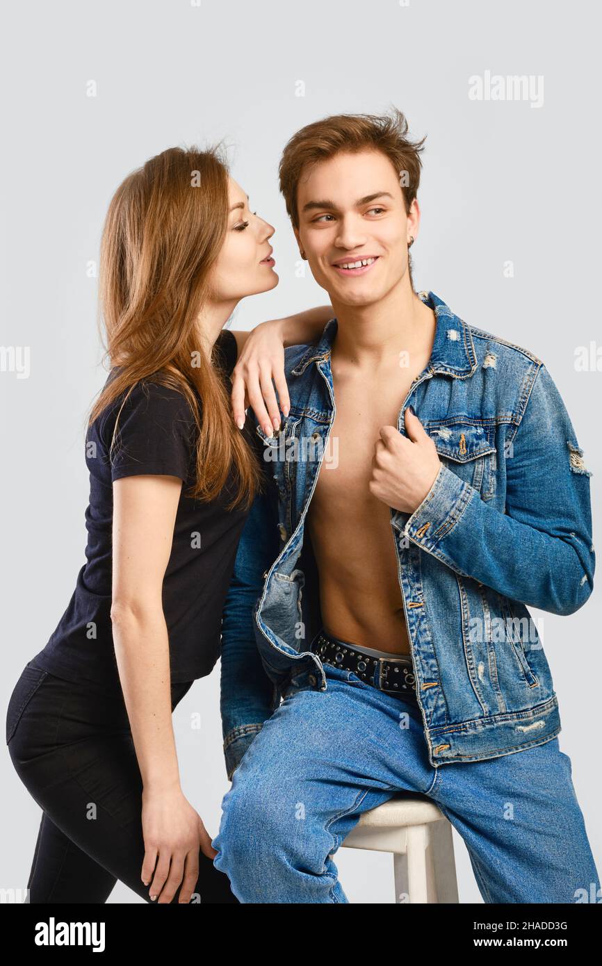 Denim clothes concept. Young woman leaning to man shoulder. Stock Photo