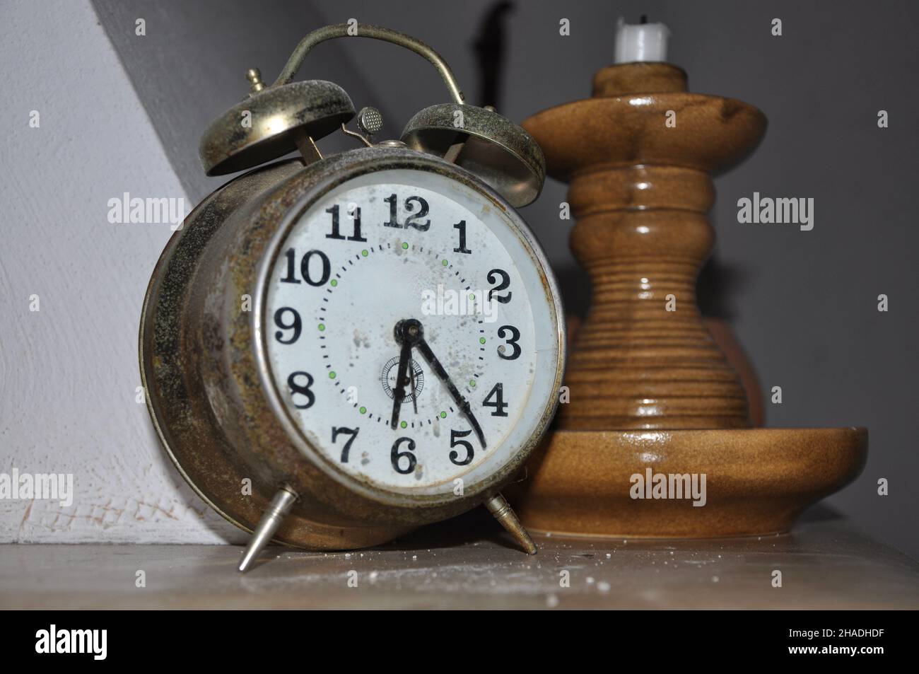 Old winding alarm clock and wooden candlestick Stock Photo Alamy