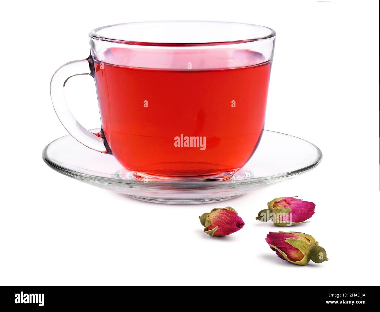 Glass transparent cup of rose tea on a saucer and three buds dried ...