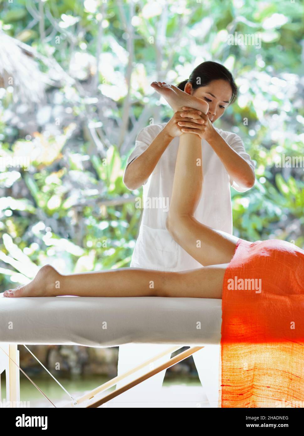 A woman receives a Fusion Massage at Six Senses Spa. The Fusion Massage is an 80-minute treatment combining Swedish, Thai, Aroma therapy Stock Photo