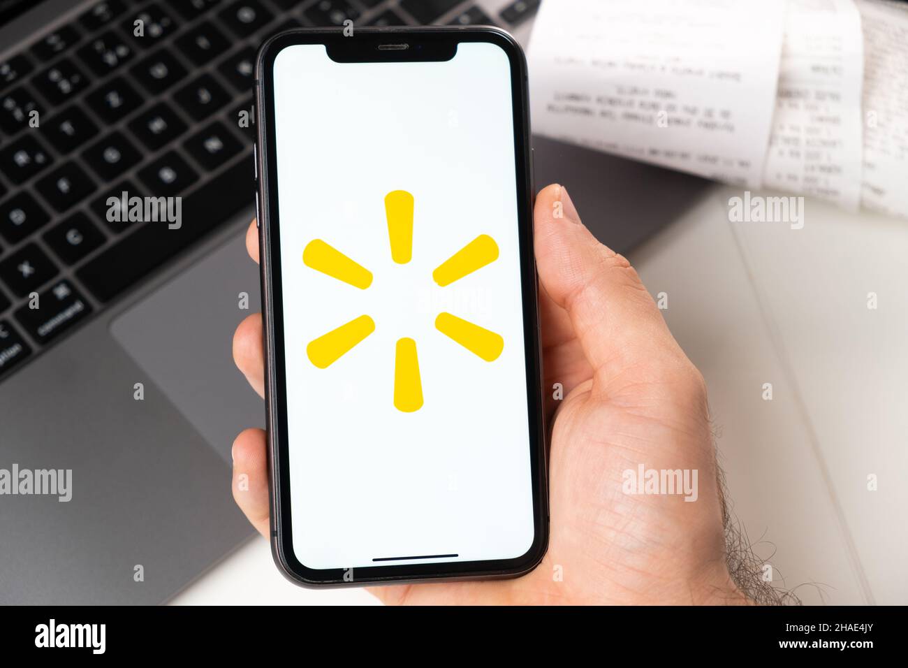 Walmart mobile application of supermarkets and grocery chains is opened in a smartphone. Buying groceries online. A man uses a food delivery service in smartphone app November 2021, San Francisco, USA Stock Photo